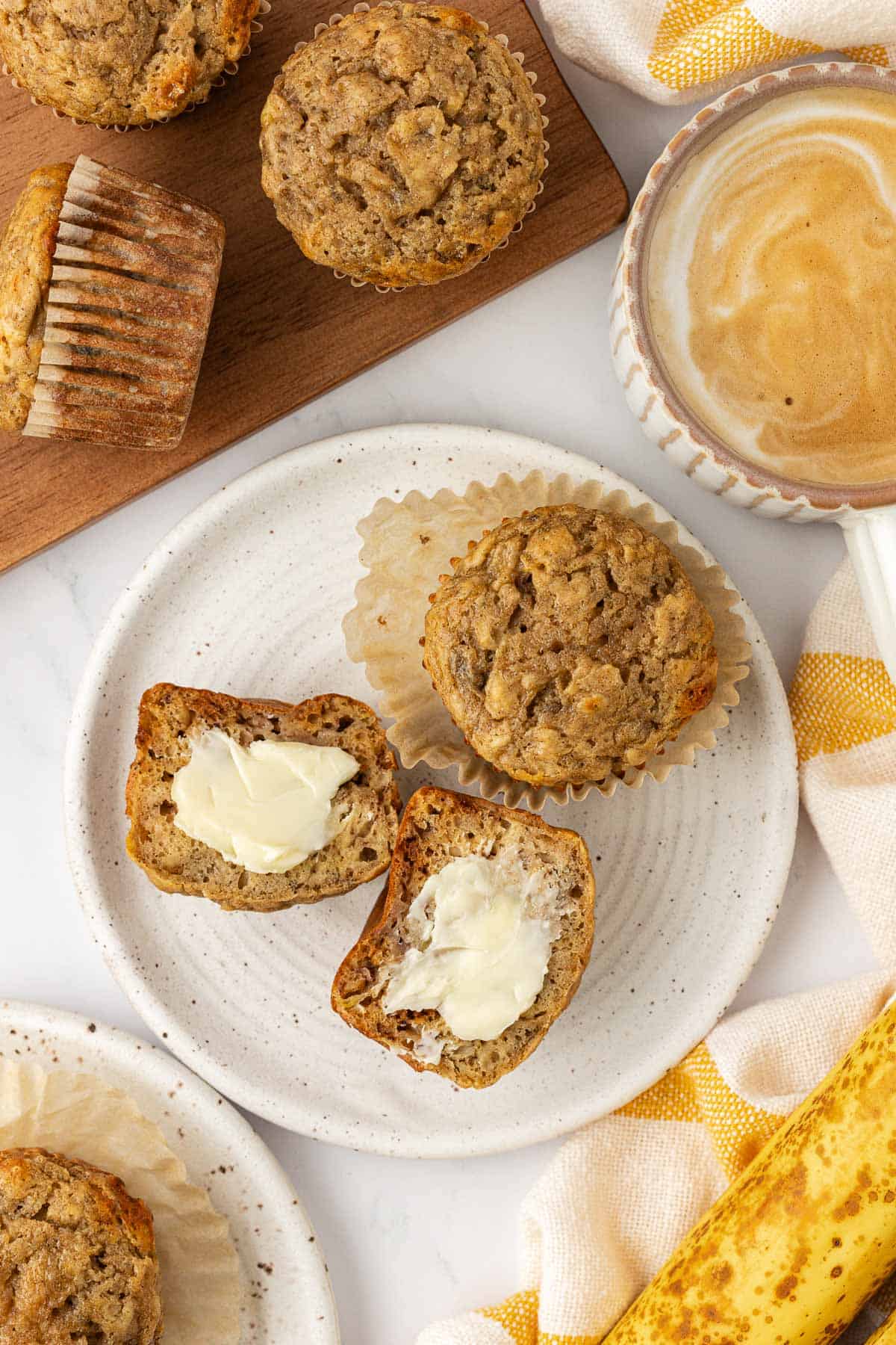 banana muffin cut in half and topped with butter