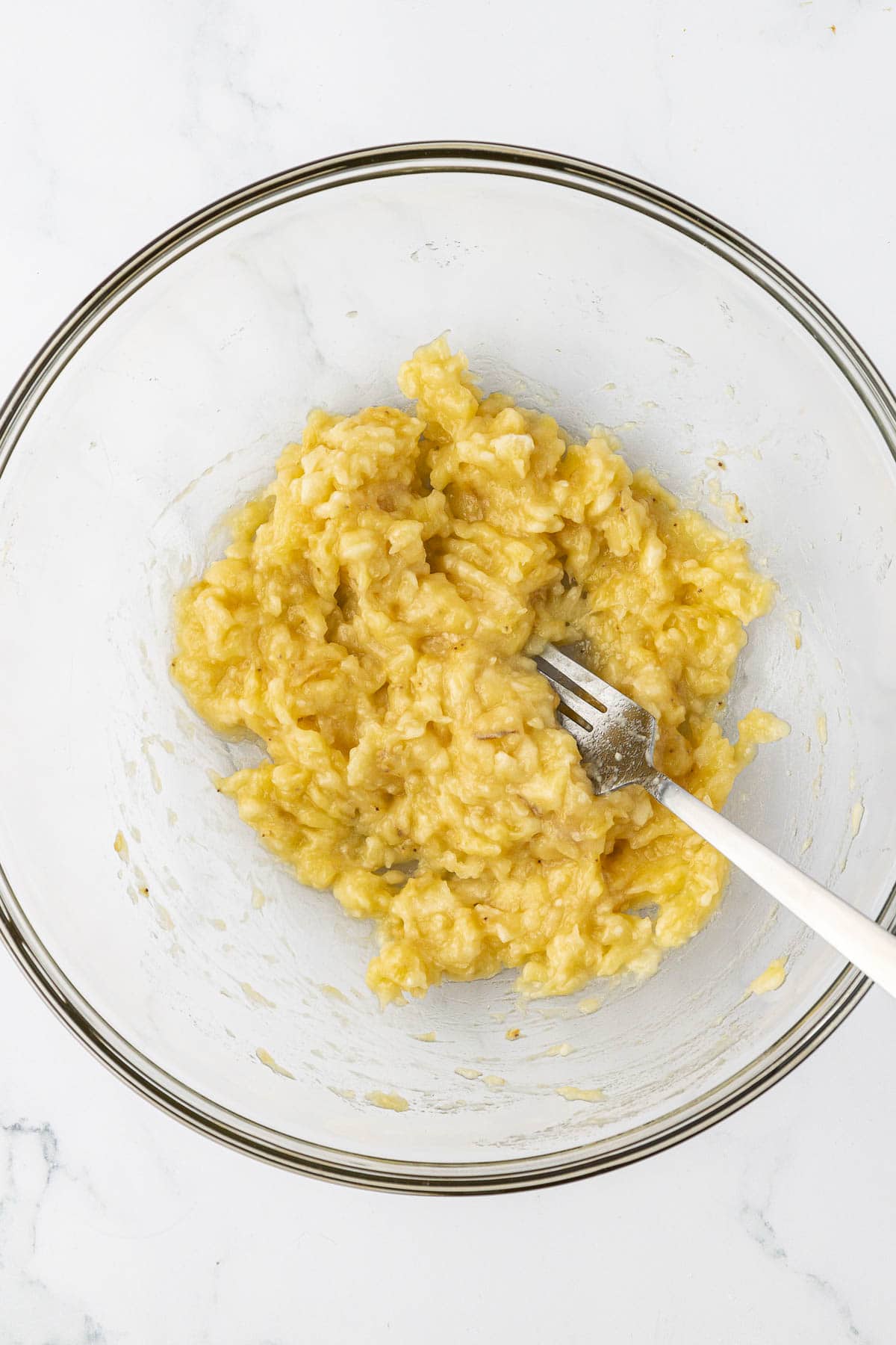 ripe mashed bananas in a mixing bowl