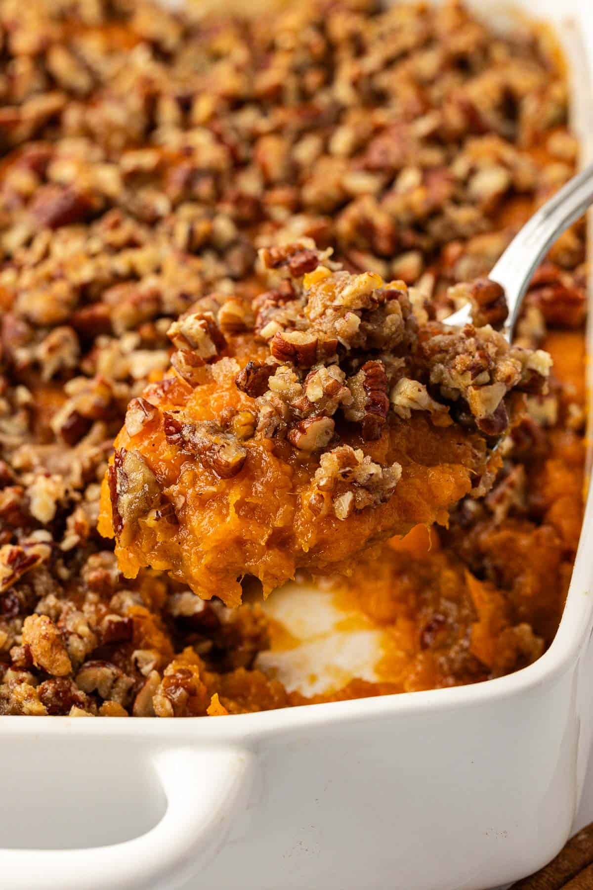 serving spoon with a scoop of sweet potato casserole