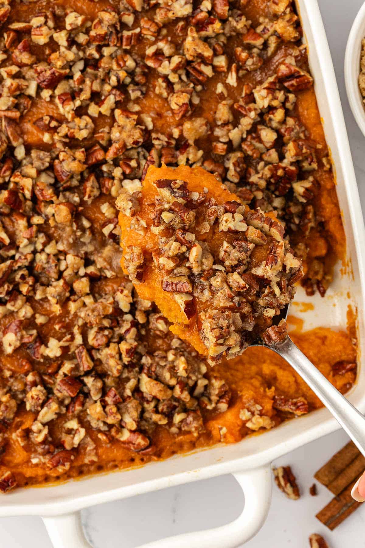 serving spoon with a scoop of sweet potato casserole
