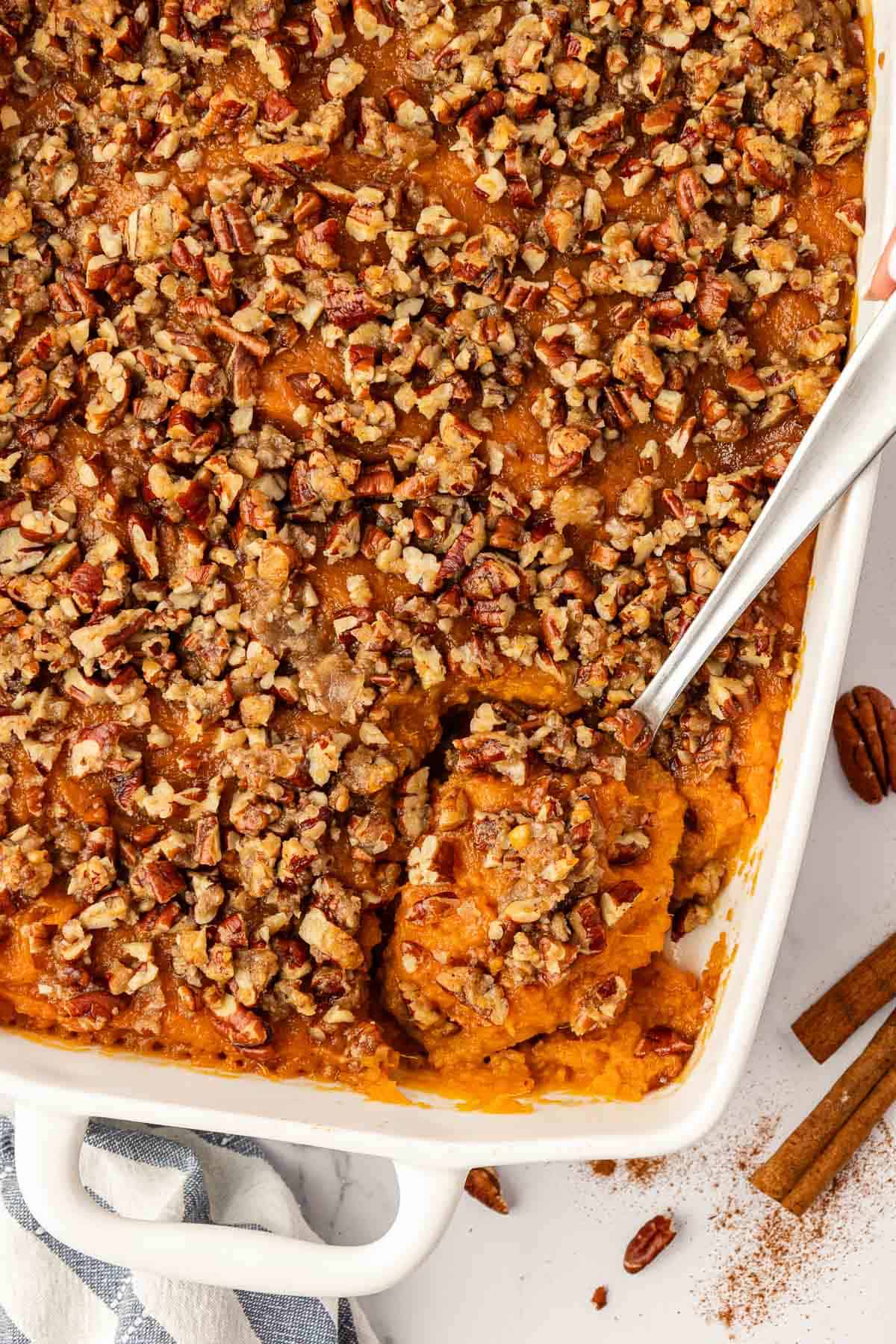 sweet potato casserole with pecans in a baking dish