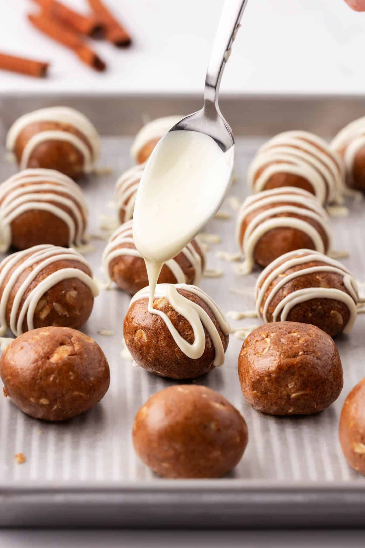 drizzling white chocolate over energy bites