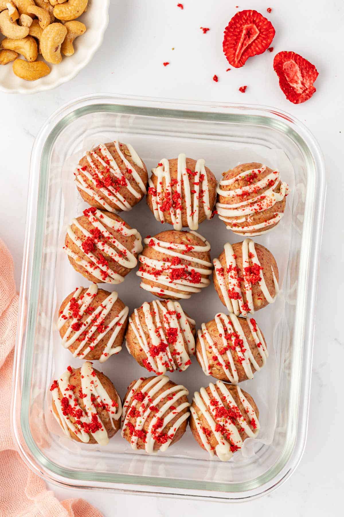 strawberries and cream energy bites in a storage container