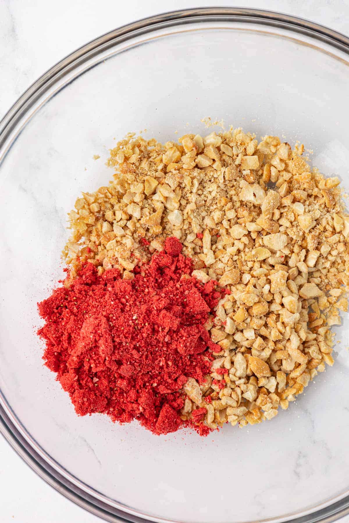 pulsed cashews and crushed freeze dried strawberries in a bowl