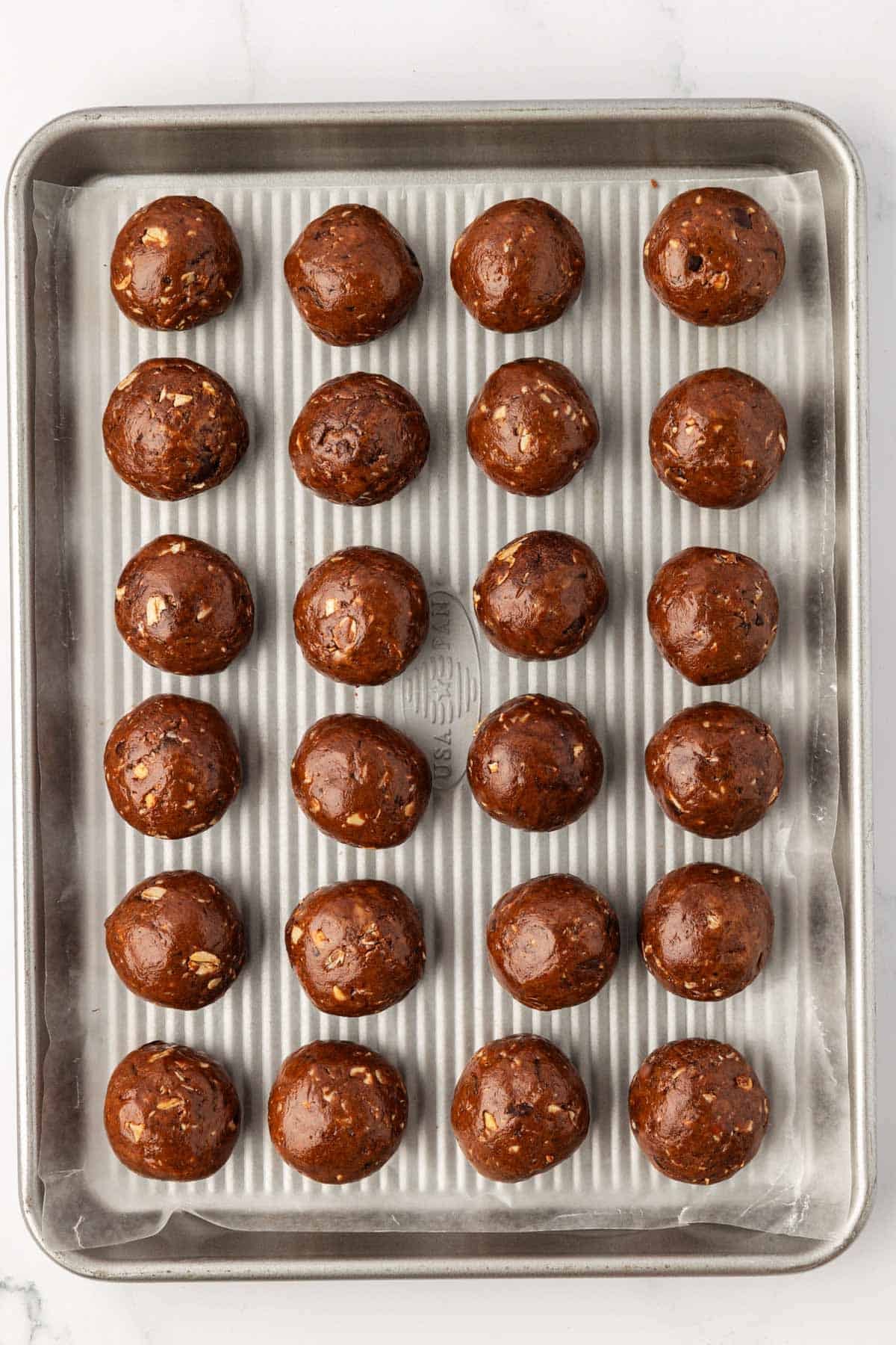 chocolate cashew energy bites on a baking sheet