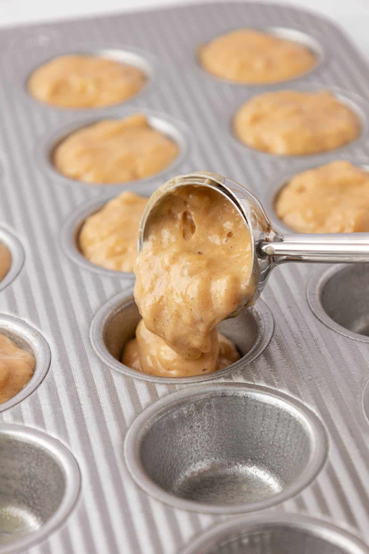 pouring the muffin batter into a mini muffin tin