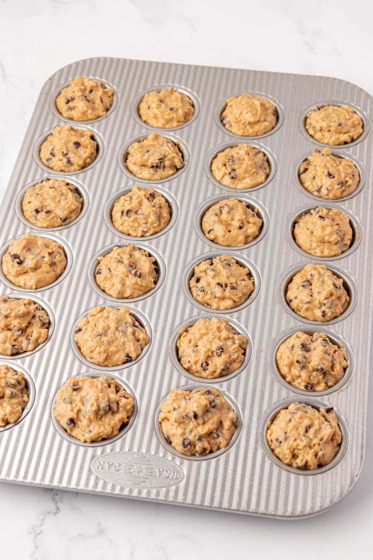 mini muffin tin filled with batter