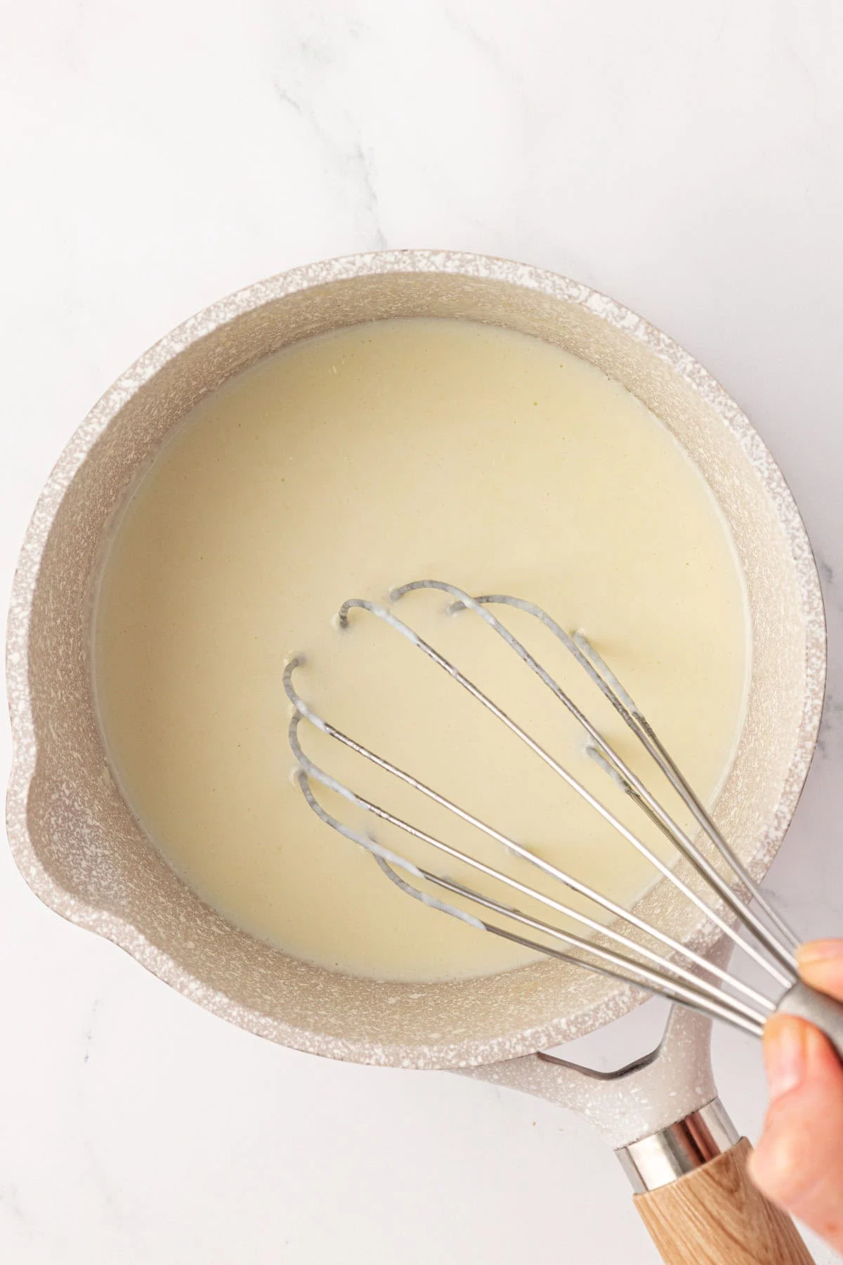 whisking the milk in
