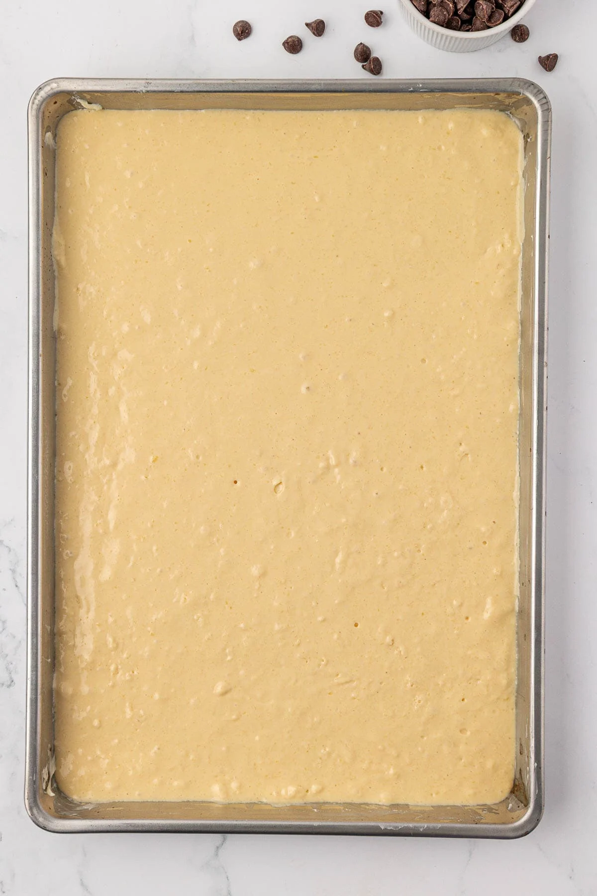 batter spread out on a sheet pan