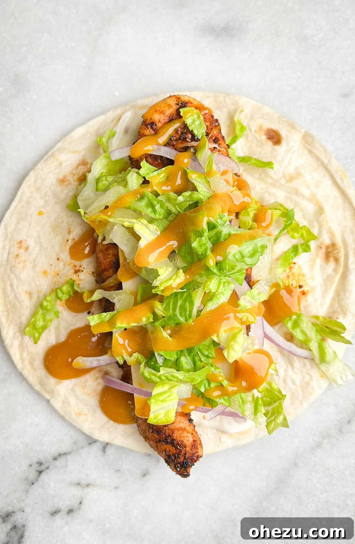 Cajun Chicken Wraps 8 Assembling a chicken snack wrap with all the fresh ingredients