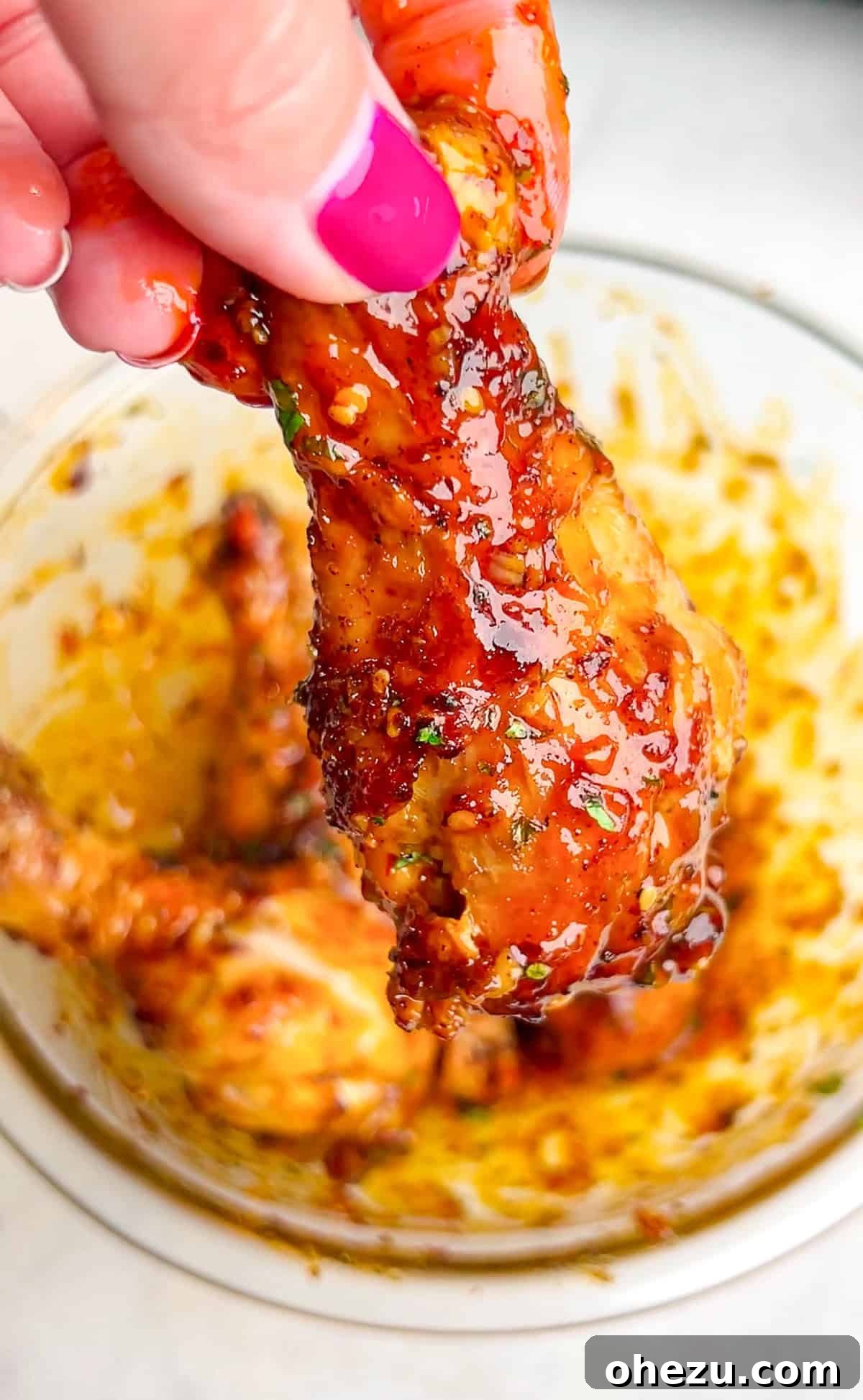 Crispy Air-Fried Sweet Chili Wings 4 Assortment of fresh ingredients for sweet chili chicken wings, including whole chicken wings, lime, cilantro, garlic, butter, and seasonings, neatly arranged.