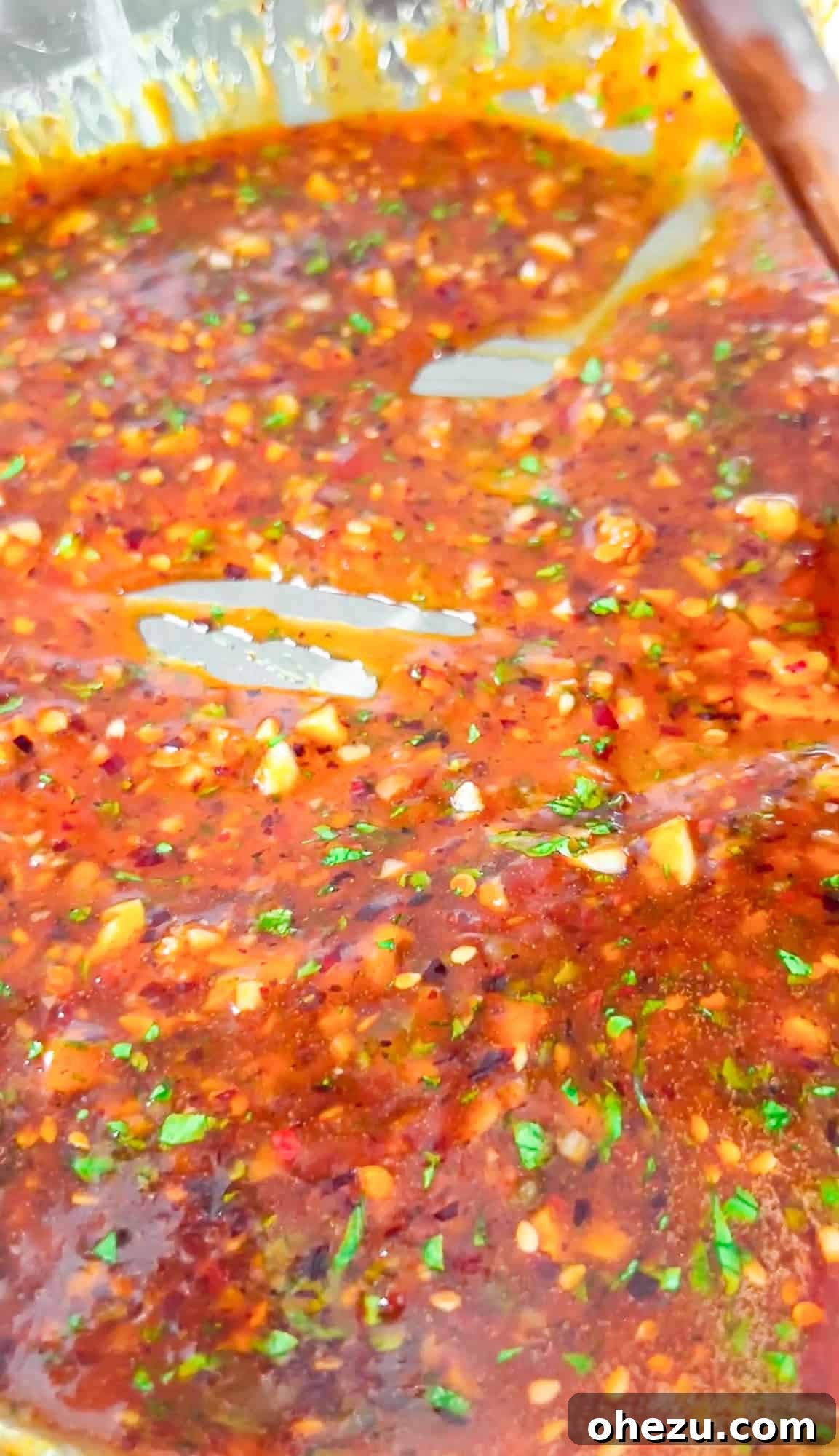 Crispy Air-Fried Sweet Chili Wings 9 Sweet chili sauce simmering in a saucepan with garlic, chili crunch, and lime juice, forming a thick glaze.