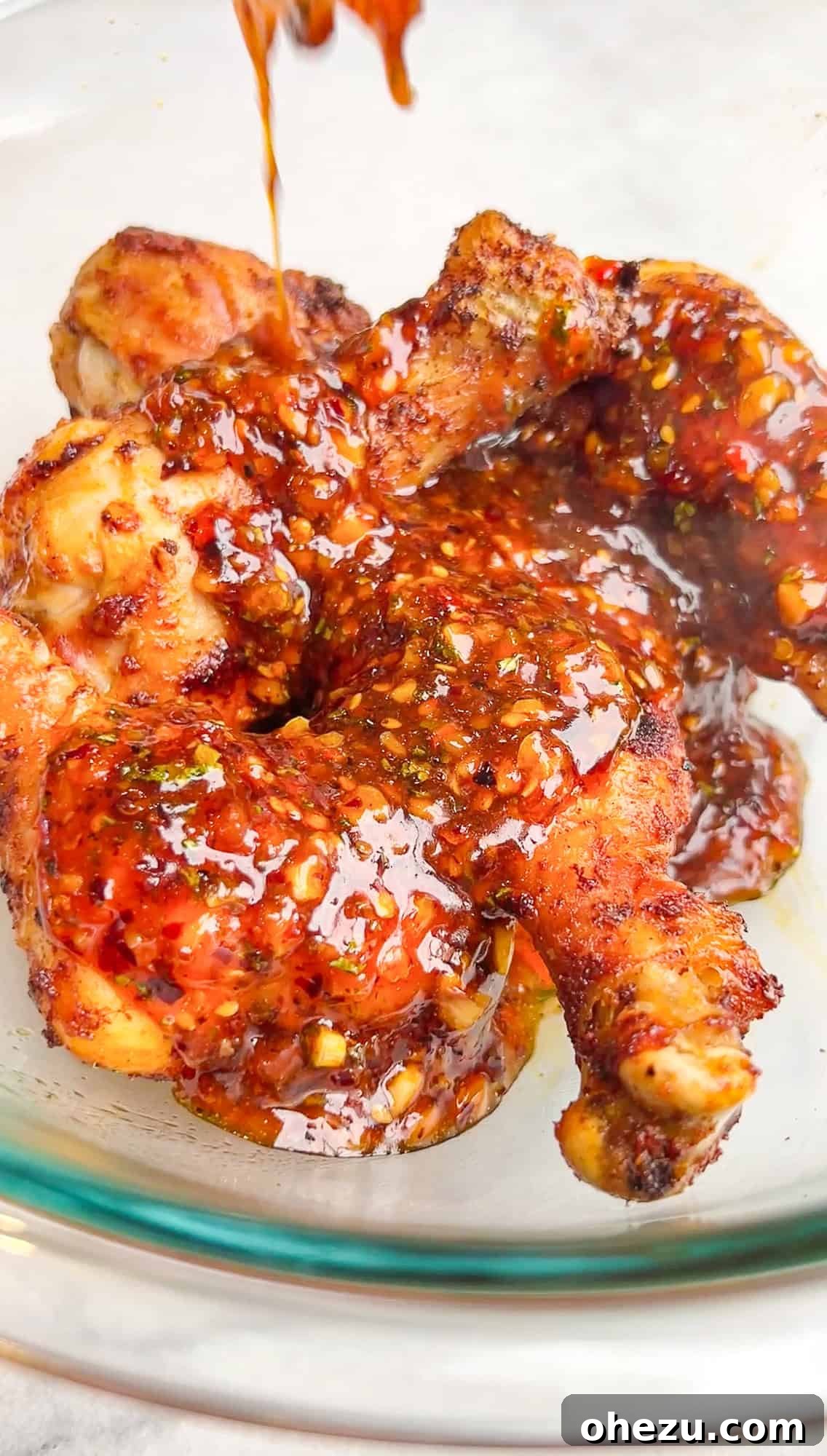 Crispy Air-Fried Sweet Chili Wings 10 Freshly air fried chicken wings coated in sticky sweet chili sauce in a large bowl, ready to be served.