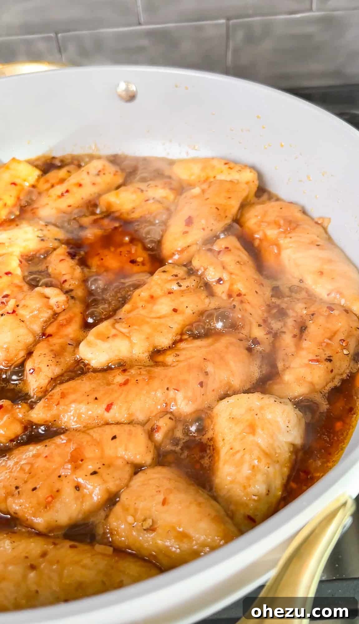 chicken simmering in sauce