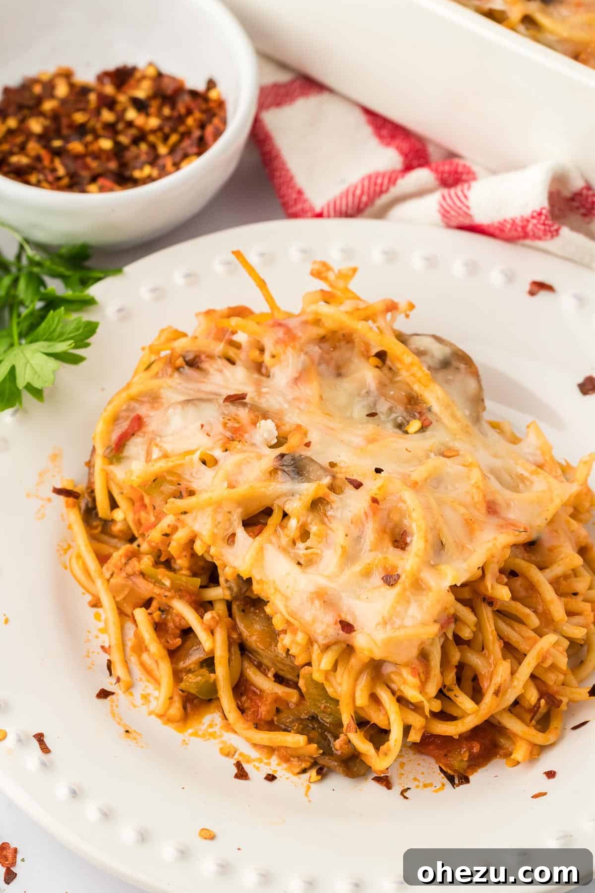 A close-up of a serving of veggie spaghetti on a plate, showing the texture and ingredients, ready to be eaten.