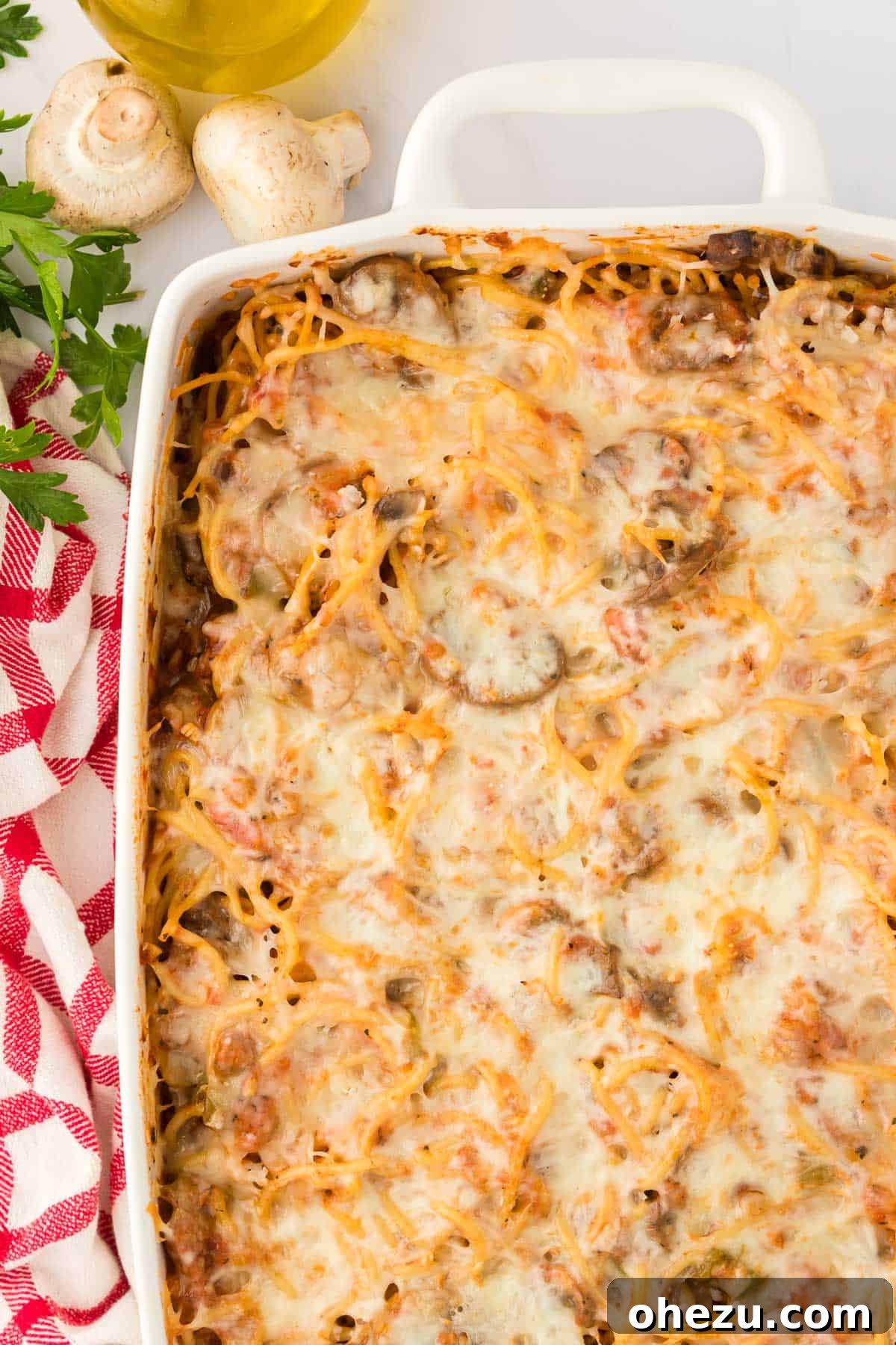 A close-up view of the baked veggie spaghetti, capturing the appetizing texture of the pasta, vegetables, and melted cheese.