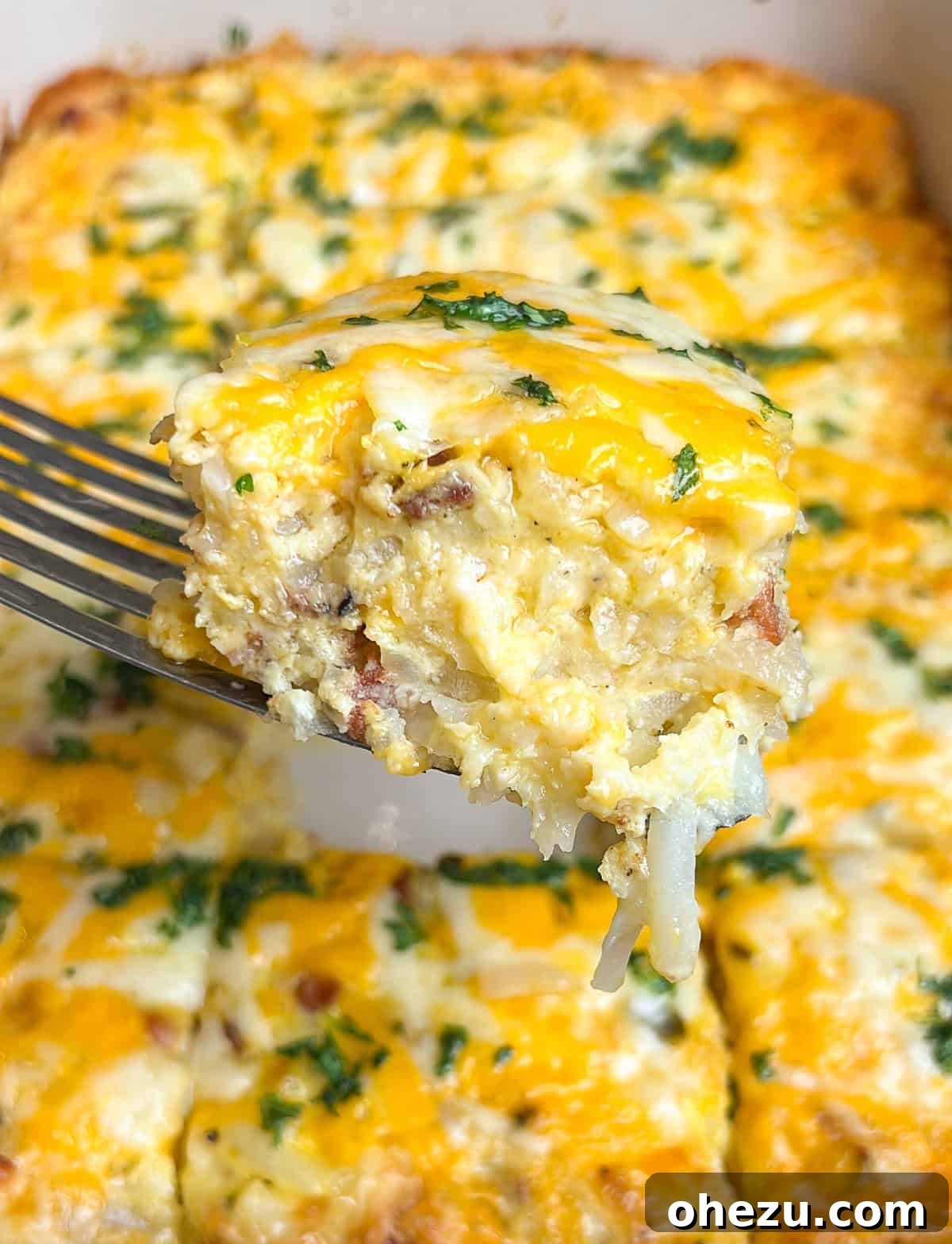 Overhead view of a cooked breakfast casserole with hashbrowns, eggs, cheese, and bacon