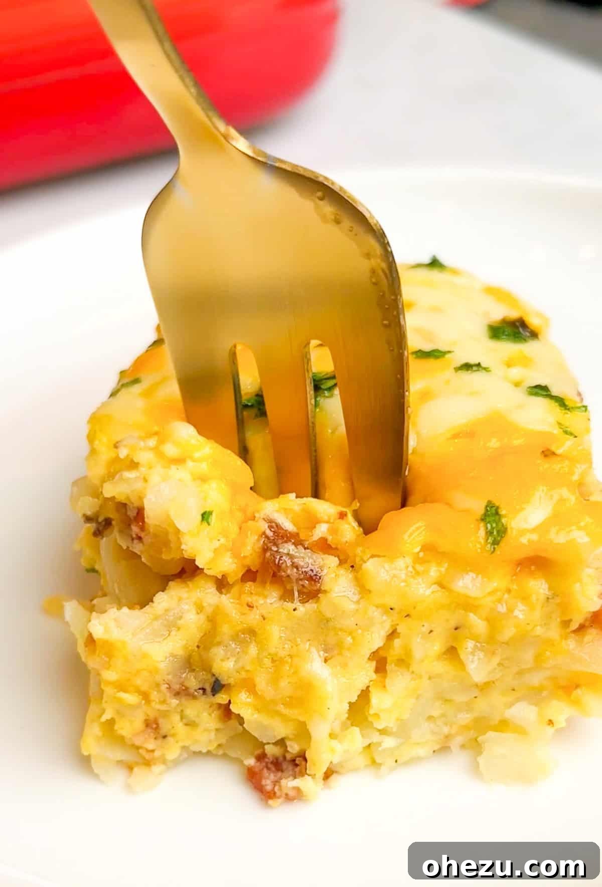Ingredients for breakfast casserole laid out on a kitchen counter, including hashbrowns, eggs, cheese, and bacon