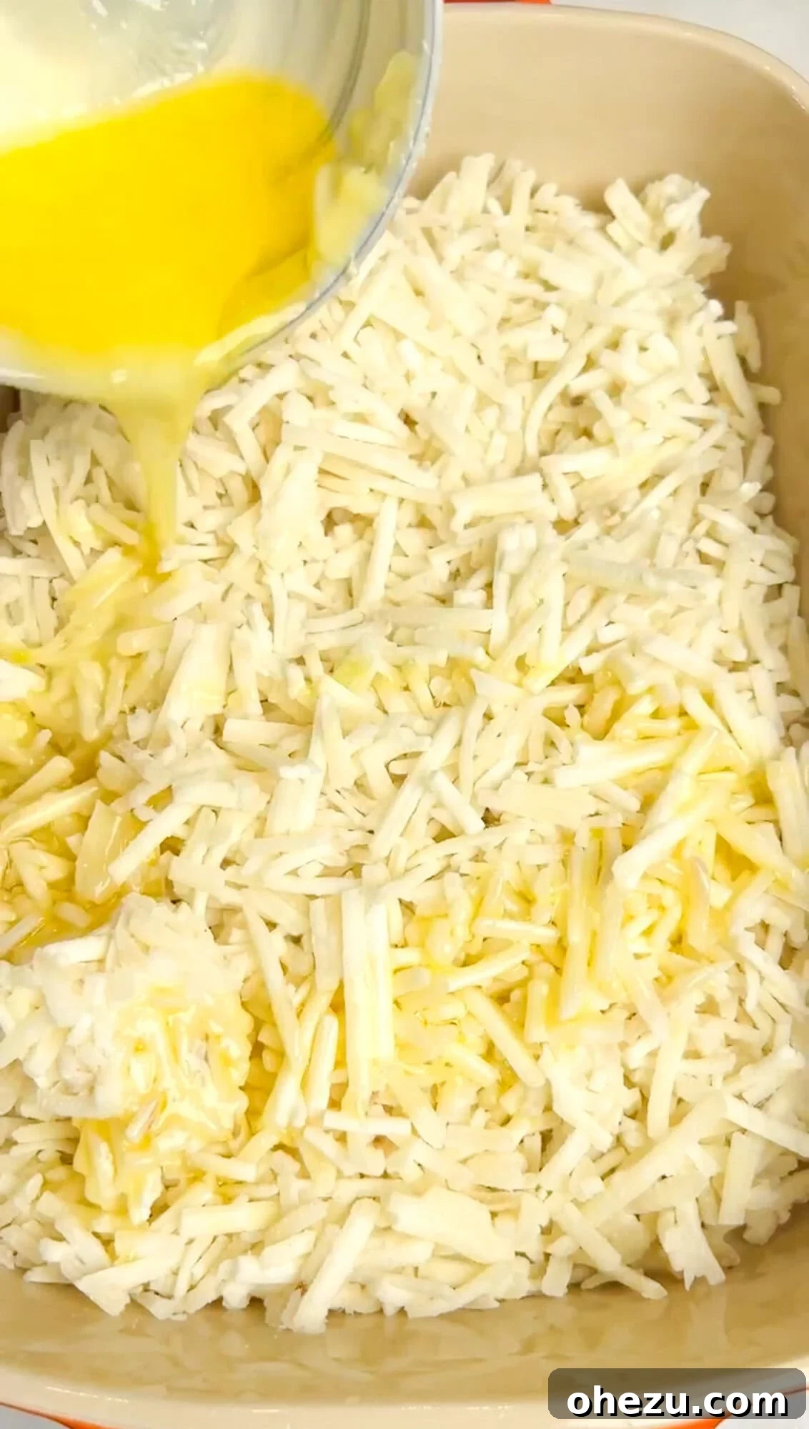 Spreading frozen hashbrowns into a greased baking dish