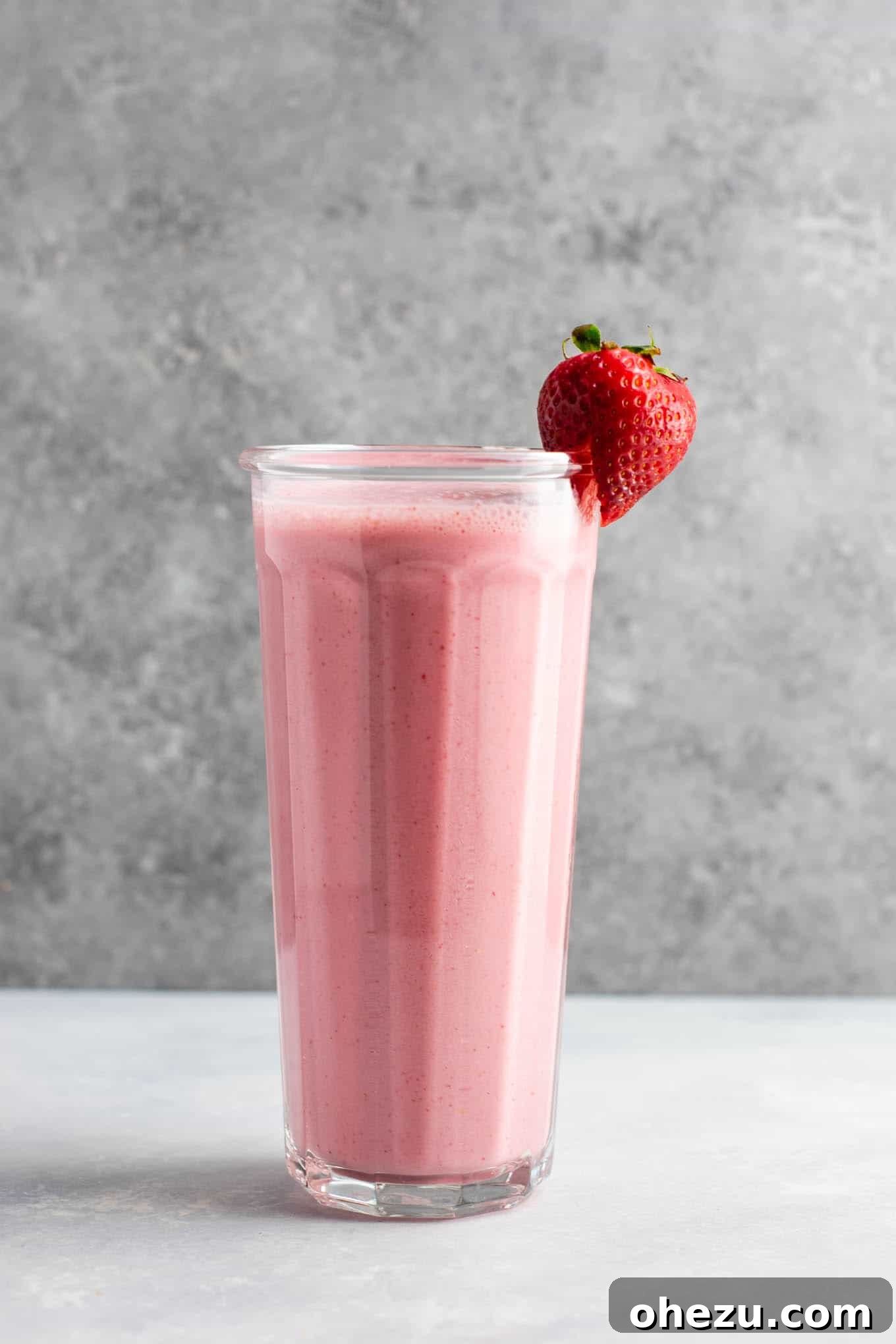 Delicious strawberry smoothie recipe, thick and vibrant, served in a glass