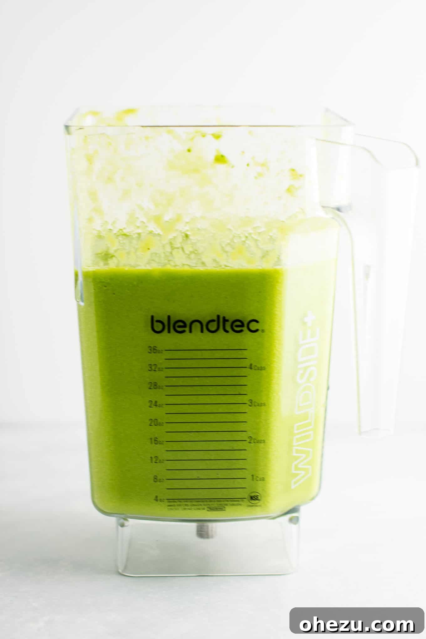 Refreshing green smoothie with healthy ingredients, featuring kale and citrus fruits