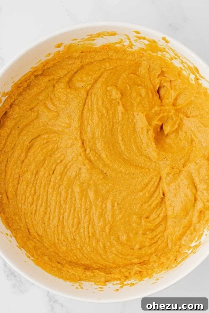 Finished pumpkin cream cheese dip, smooth and fluffy, resting in a mixing bowl