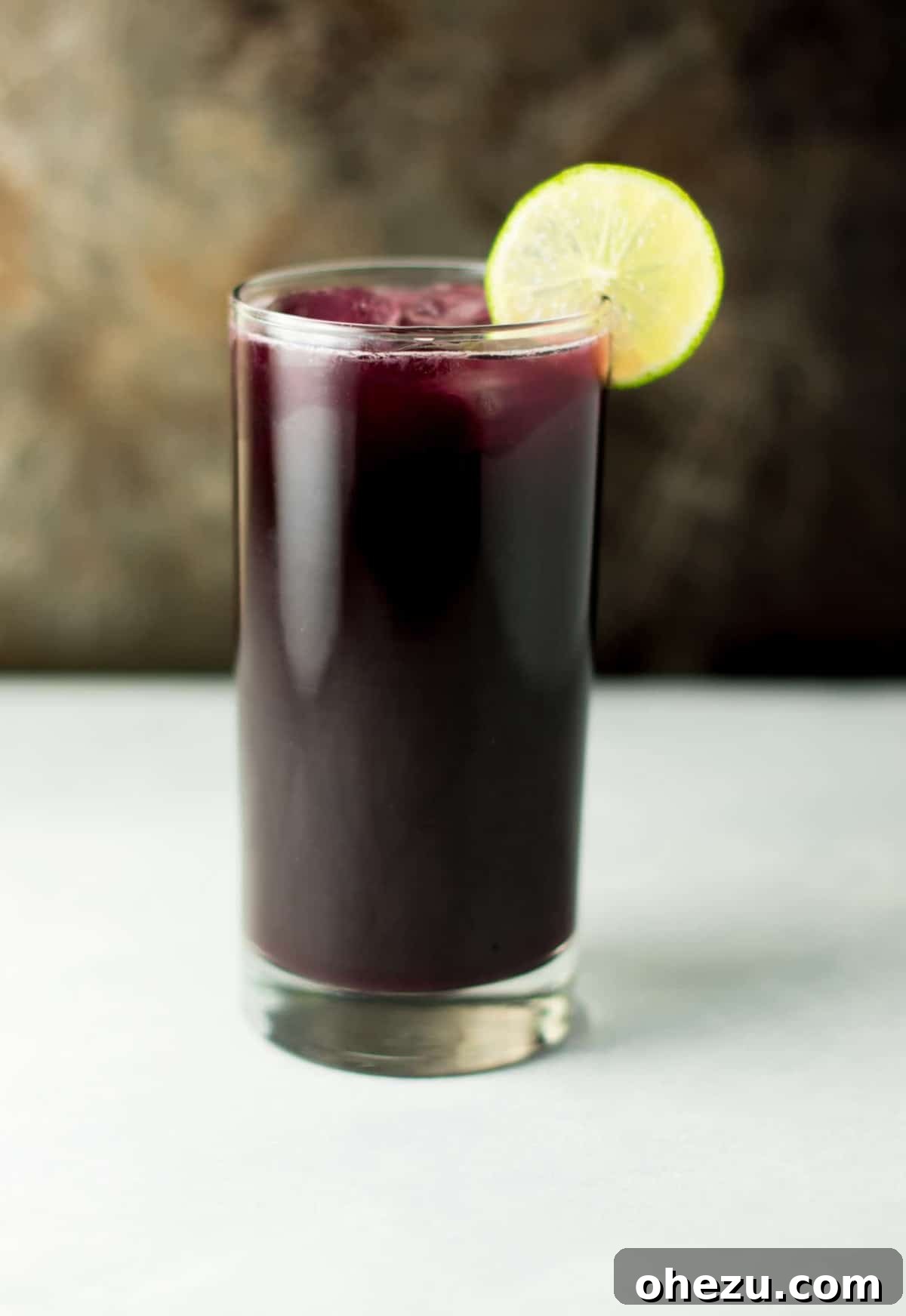 Handmade Grape Fizz 2 Refreshing glass of homemade sparkling grape soda with fresh lime slices