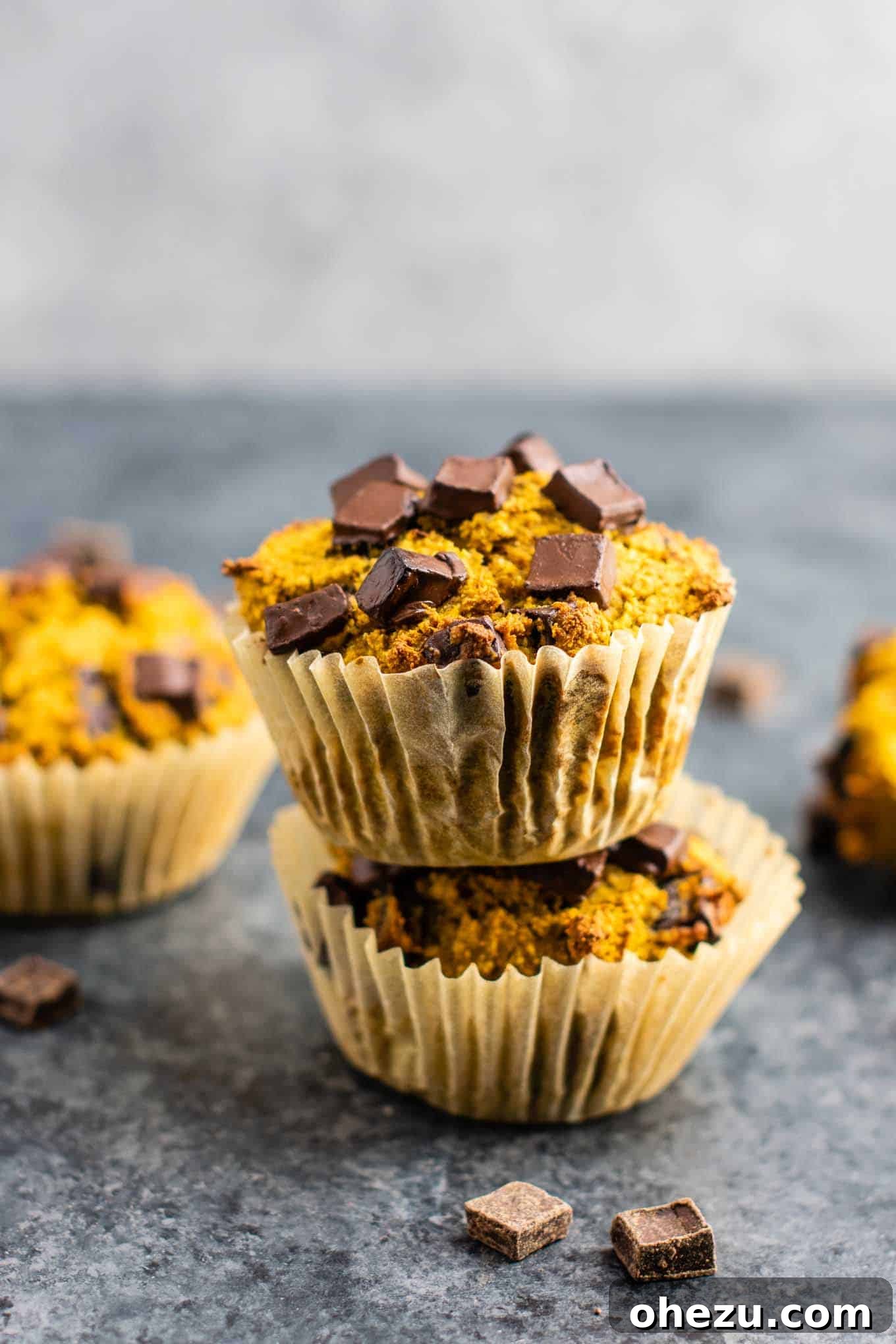 Wholesome Gluten-Free Pumpkin Muffins 3 Stack of gluten-free pumpkin muffins with dark vegan chocolate chips, invitingly presented.