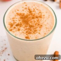 Glass full of healthy apple pie smoothie topped with cinnamon