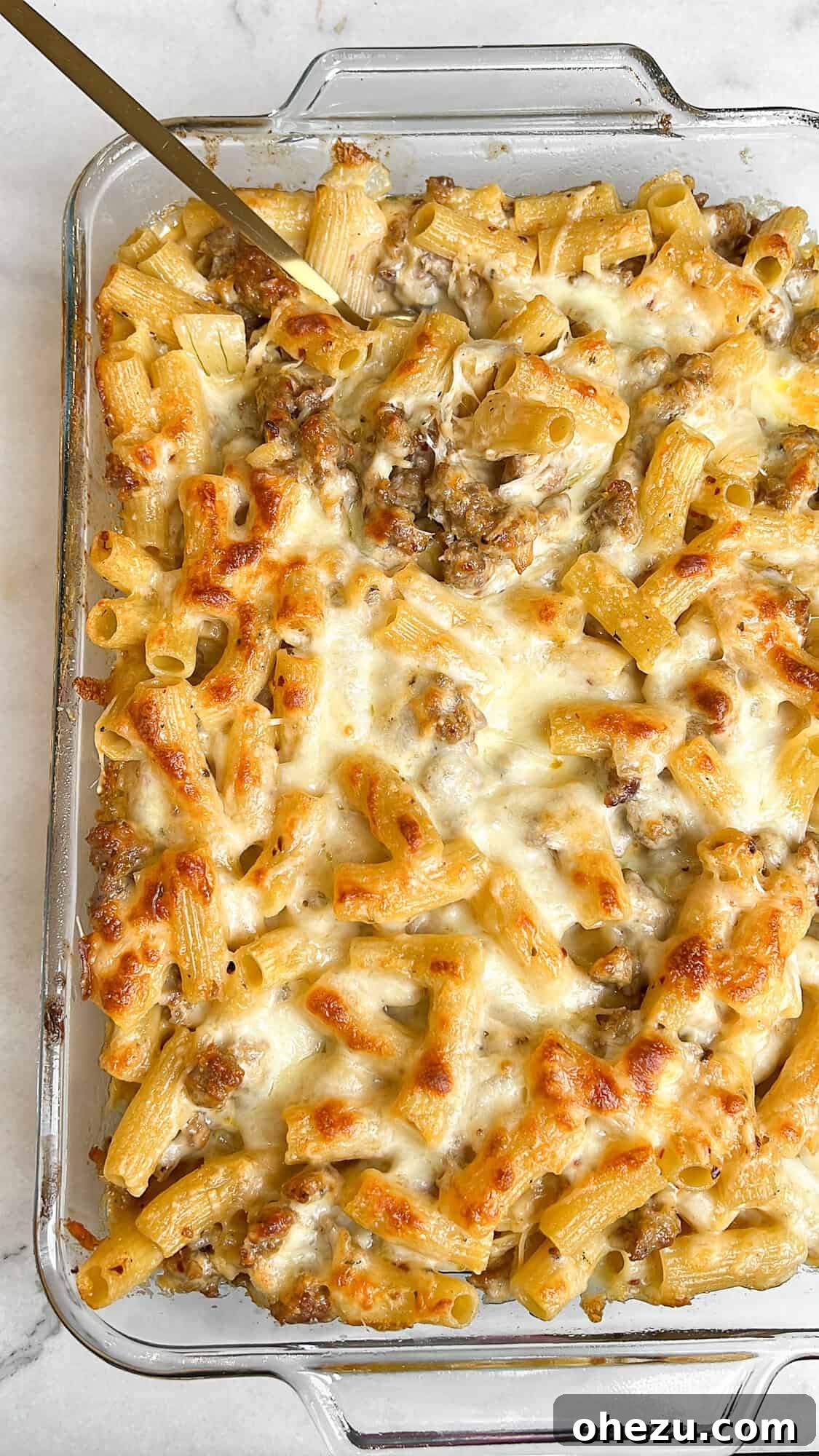 Hearty Creamy Sausage Alfredo Bake 4 sausage alfredo in a white bowl with a fork
