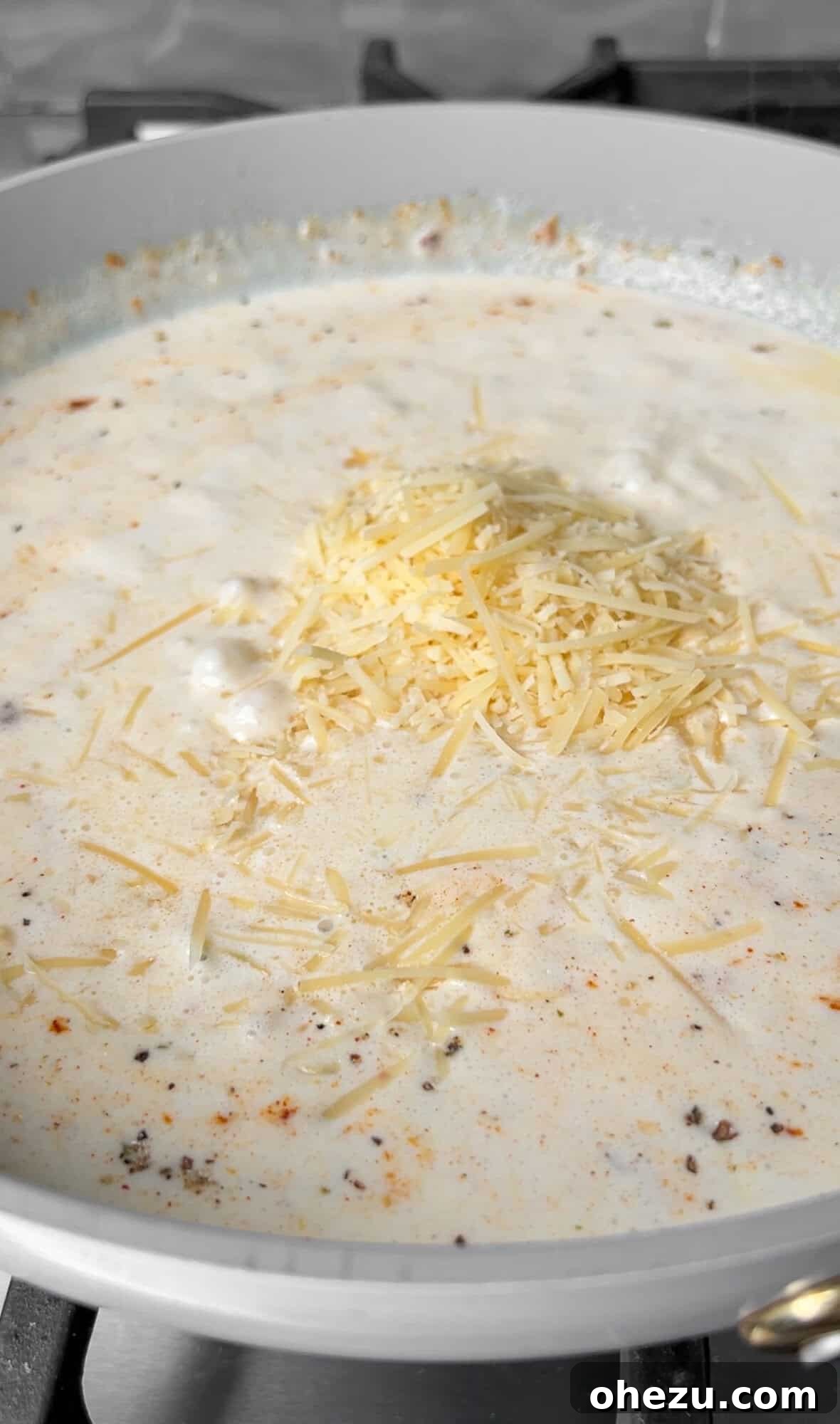 Hearty Creamy Sausage Alfredo Bake 7 making alfredo sauce in a skillet