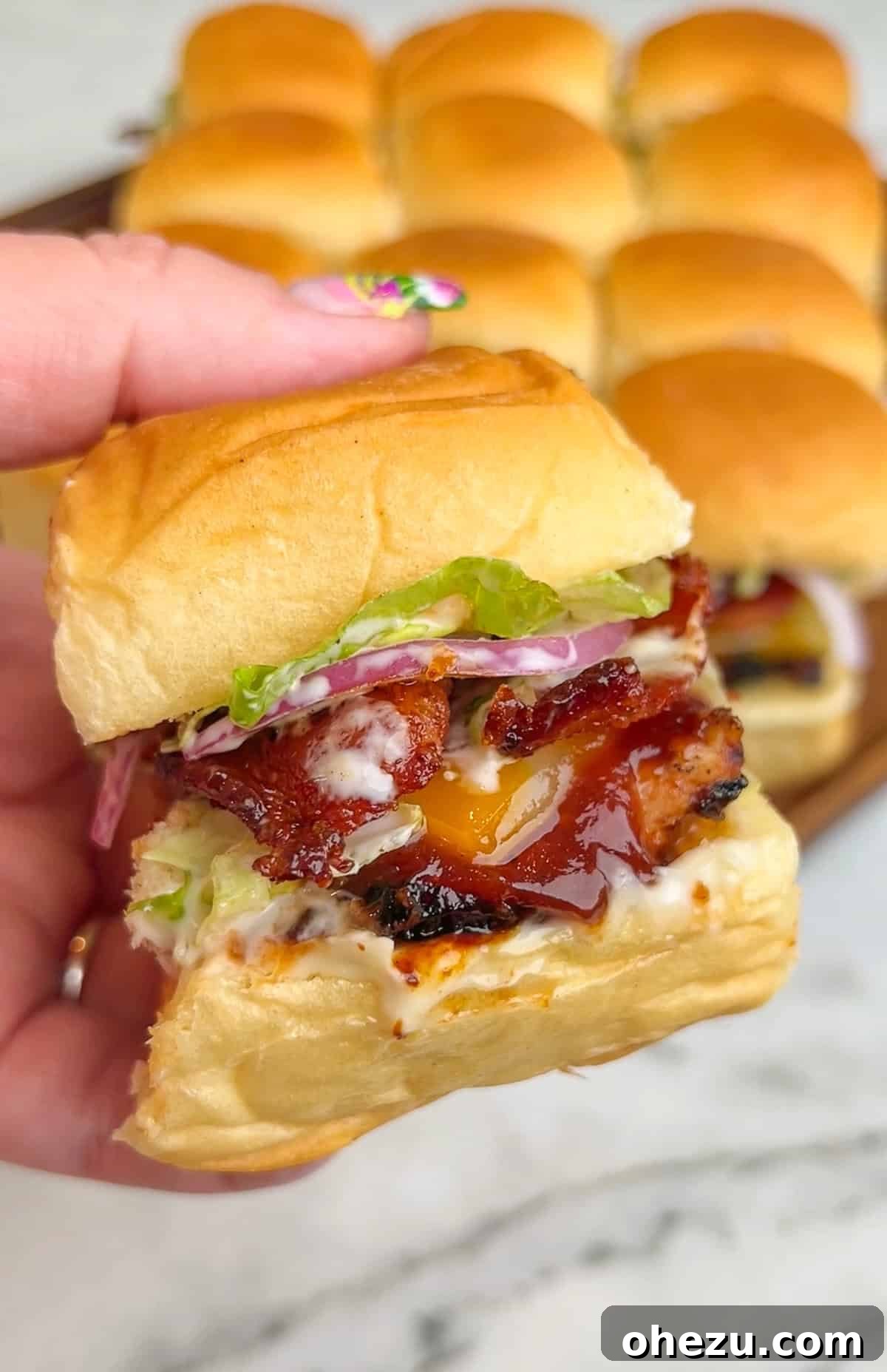 Overhead shot showcasing all the fresh and prepared ingredients neatly laid out for assembling BBQ Chicken Sliders