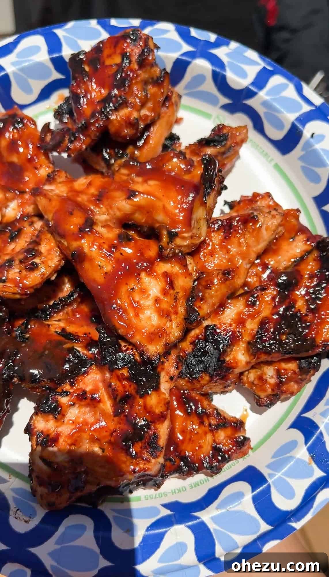 Grilling BBQ marinated chicken breasts to perfection on a hot grill
