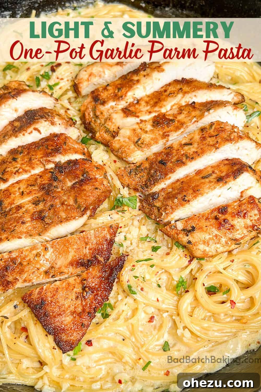 Overhead shot of one-pot garlic parmesan pasta with fresh herbs