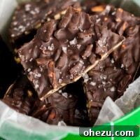 Dark chocolate almond bark studded with sea salt flakes, presented in a festive Christmas tin. This bark is easy to make and highly addictive.