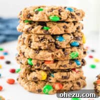 A colorful stack of gluten-free monster cookies, packed with mini chocolate chips and M&M's. These flourless cookies are made with gluten-free oats.