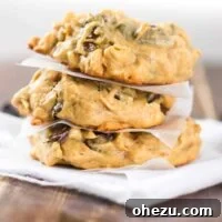A stack of perfectly baked flourless peanut butter oatmeal chocolate chip cookies, showcasing their chewy texture and rich chocolate chips. These cookies are naturally gluten-free and incredibly satisfying.