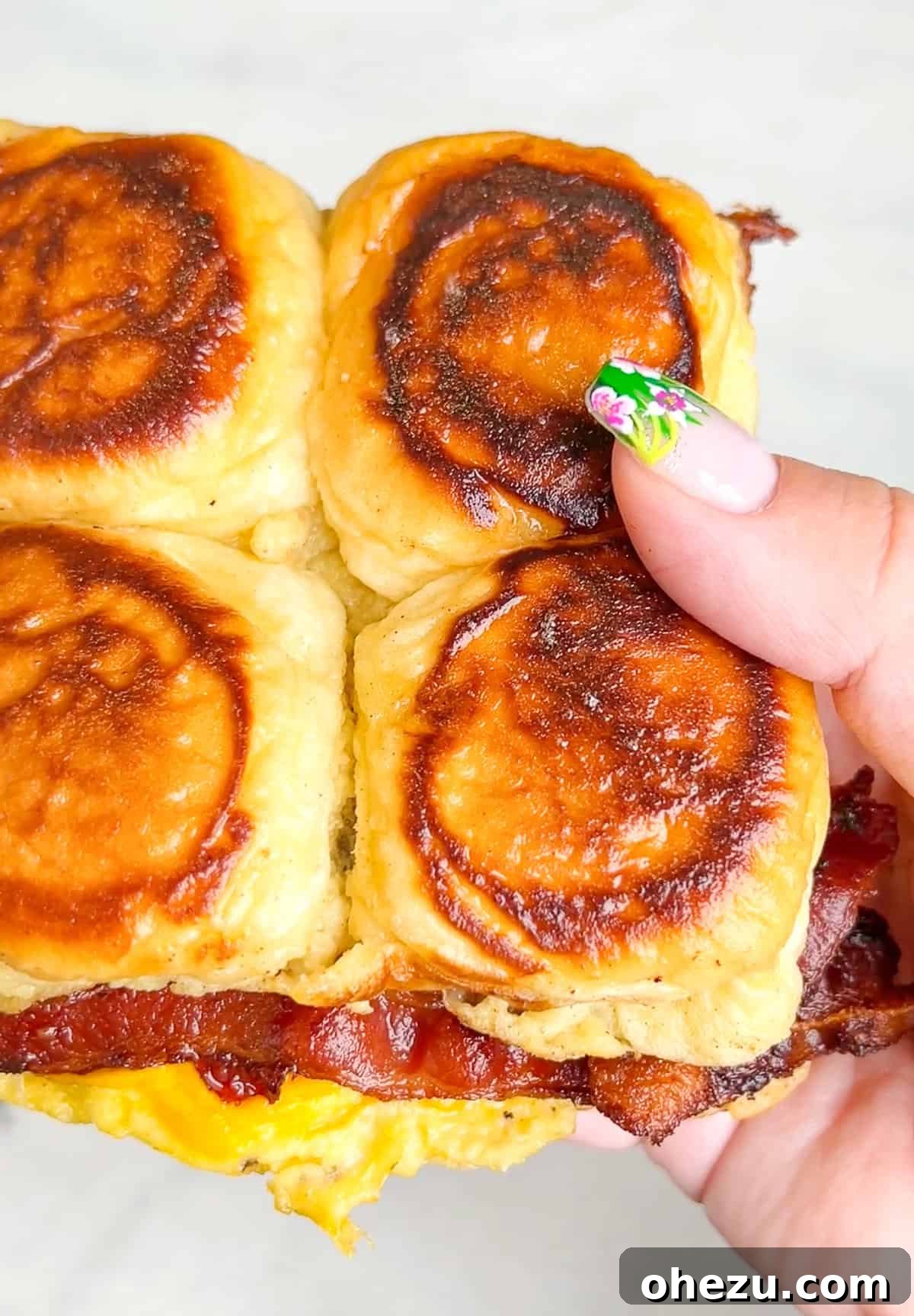 Stacked French Toast Sandwiches on Hawaiian rolls, showcasing layers