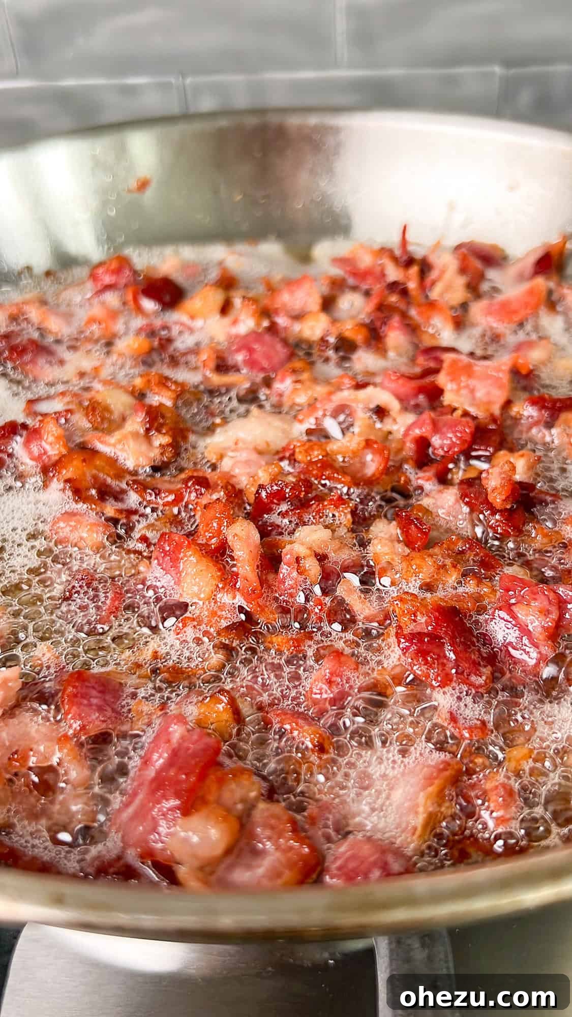 Skillet with sautéed corn kernels, lightly charred, after cooking in bacon grease.