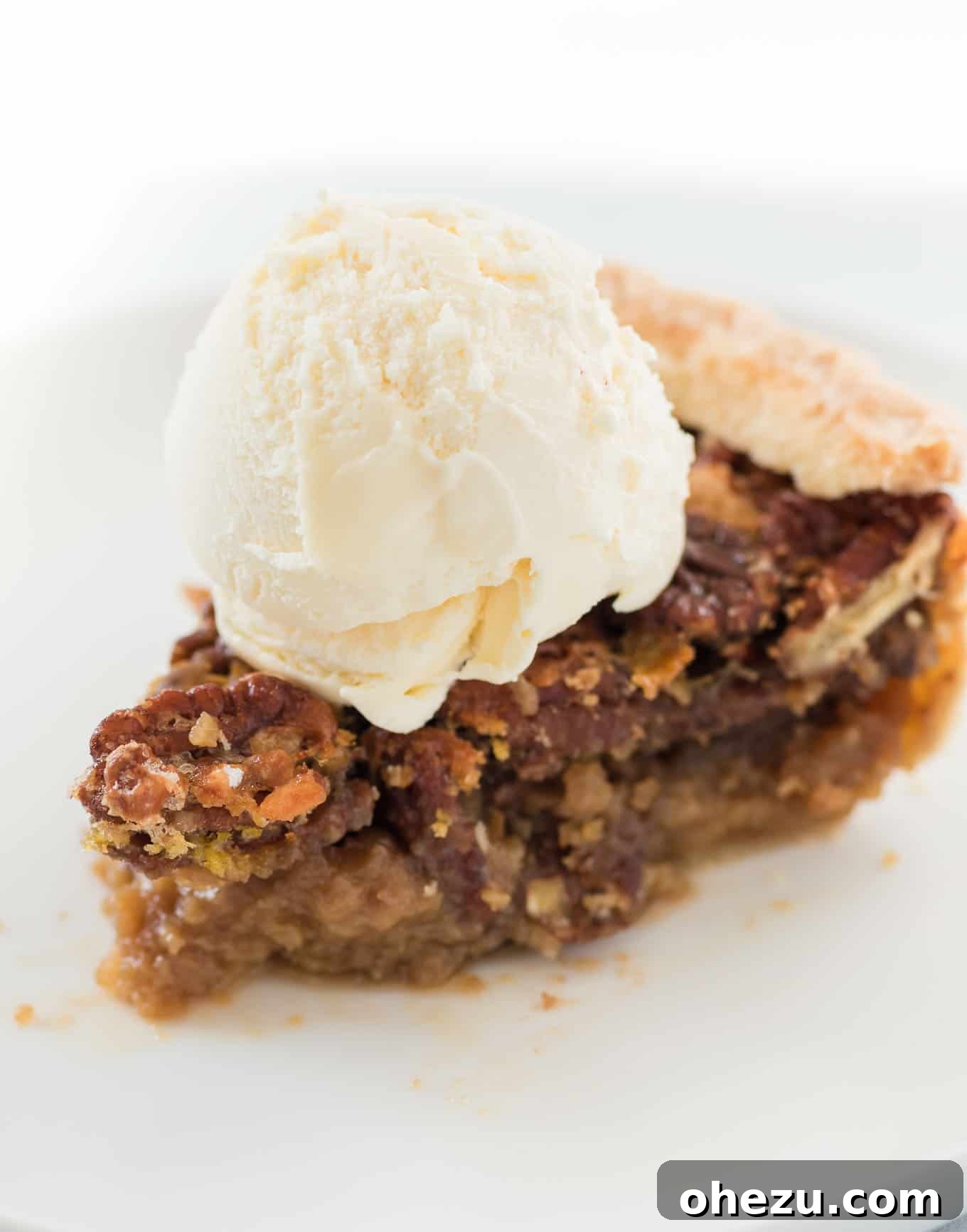 slice of pecan pie with a scoop of vanilla ice cream