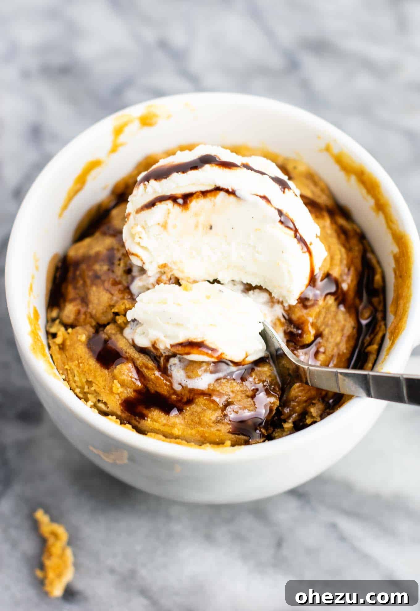 A delicious and quick microwave peanut butter cookie in a mug, perfect for a gluten-free, dairy-free, and refined sugar-free treat. It tastes incredible and pairs wonderfully with a scoop of ice cream.