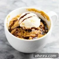 A delicious and quick microwave peanut butter cookie in a mug, perfect for a gluten-free, dairy-free, and refined sugar-free treat. It tastes incredible and pairs wonderfully with a scoop of ice cream.