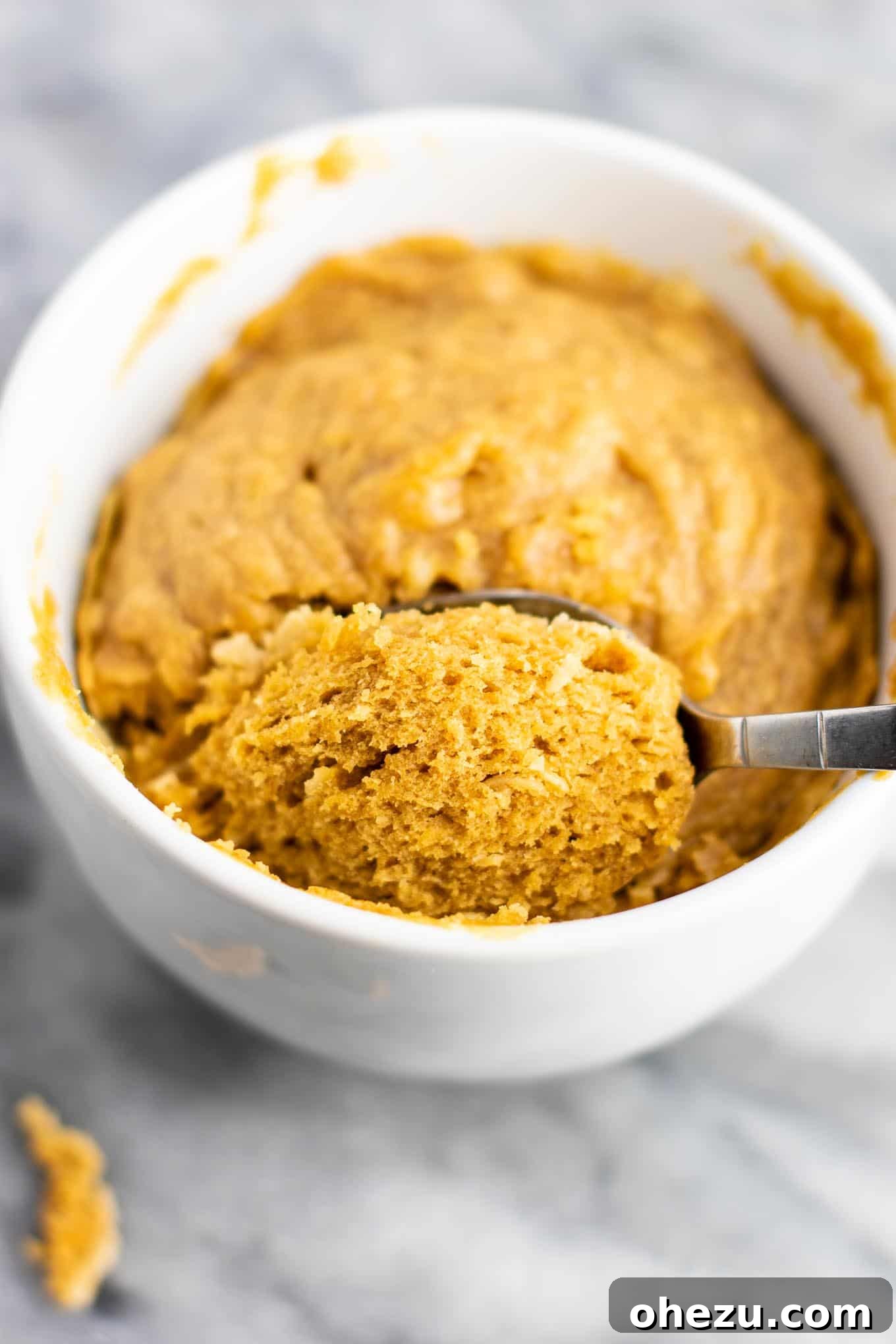 The finished peanut butter cookie in a mug, ready to be served, highlighting its rich texture and inviting appearance as a gluten-free, dairy-free, and refined sugar-free dessert.