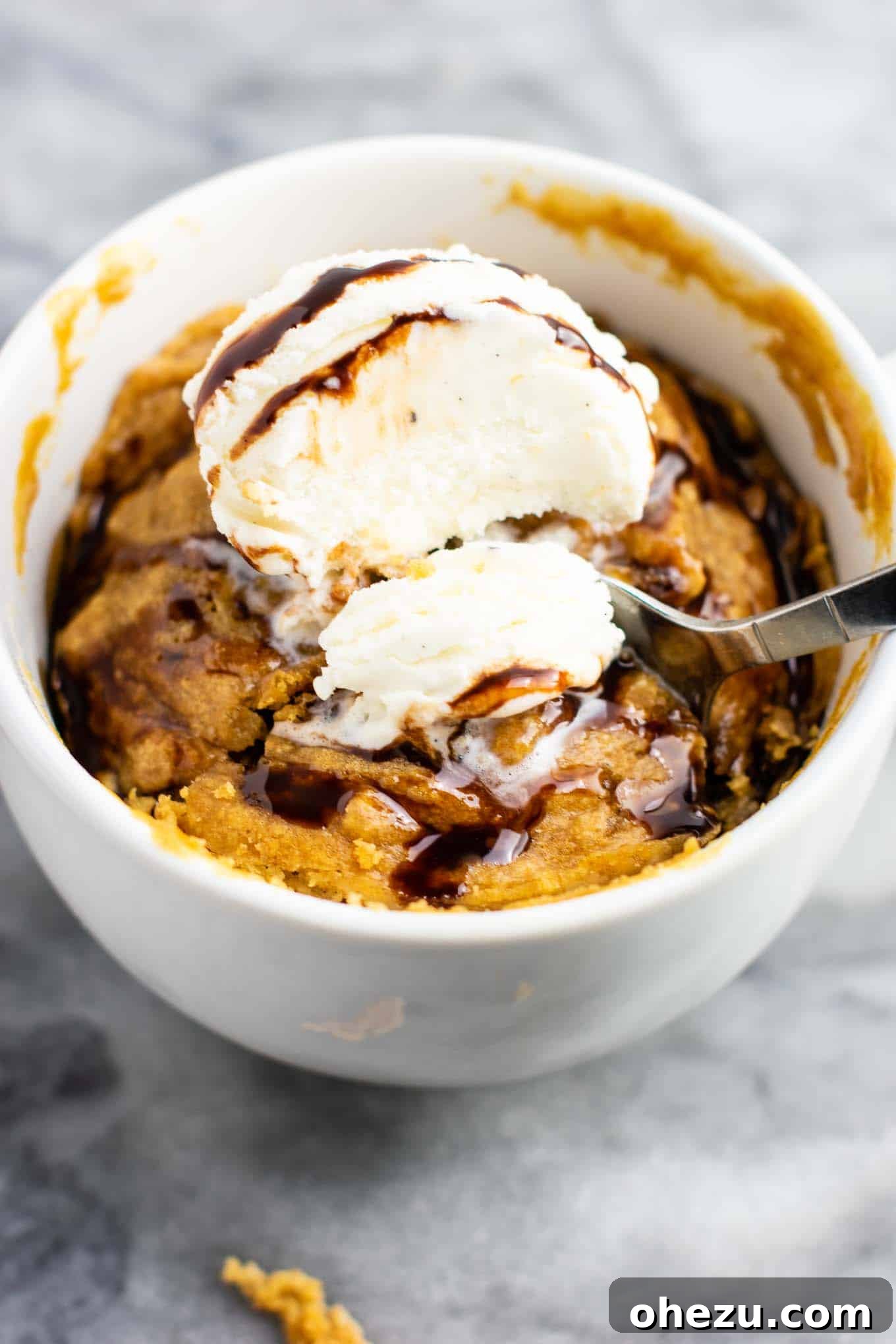 A top-down view of the peanut butter cookie in a mug, showcasing its appealing texture and rich color, ready to be enjoyed as a quick, healthy, and delicious dessert.