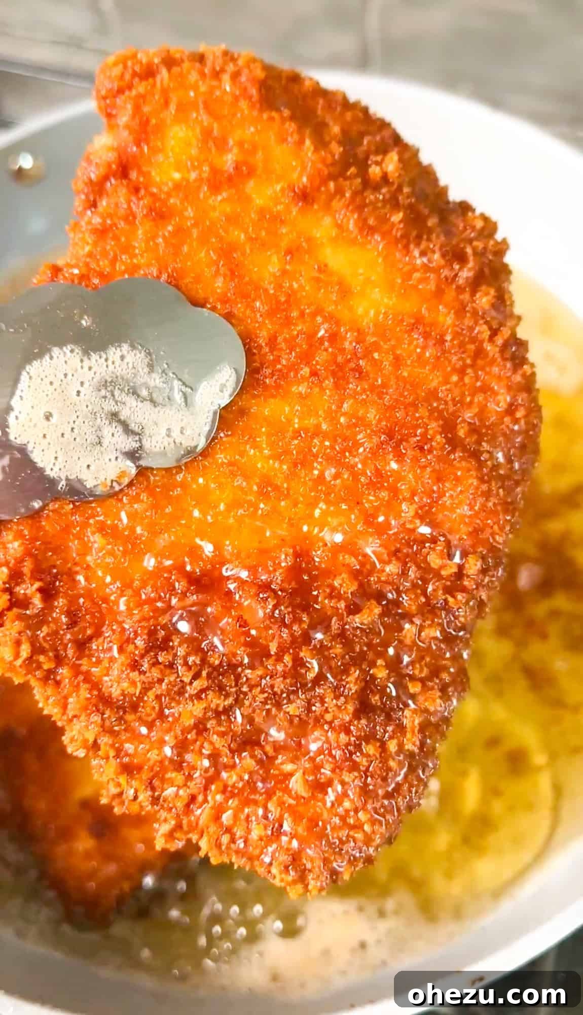Crispy panko chicken frying in a skillet