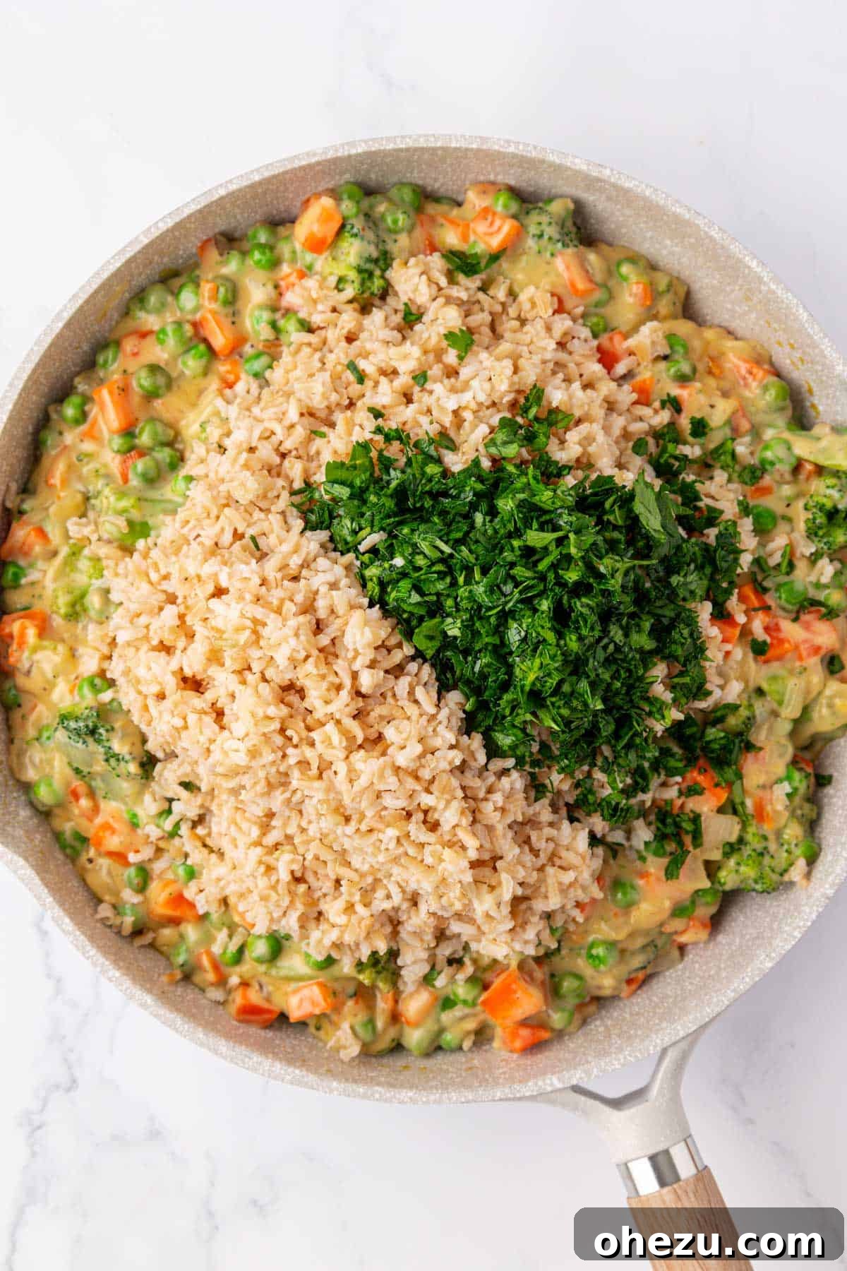 Hearty Vegetable Rice Bake 11 Mixing cooked brown rice and fresh parsley into the creamy vegetable base