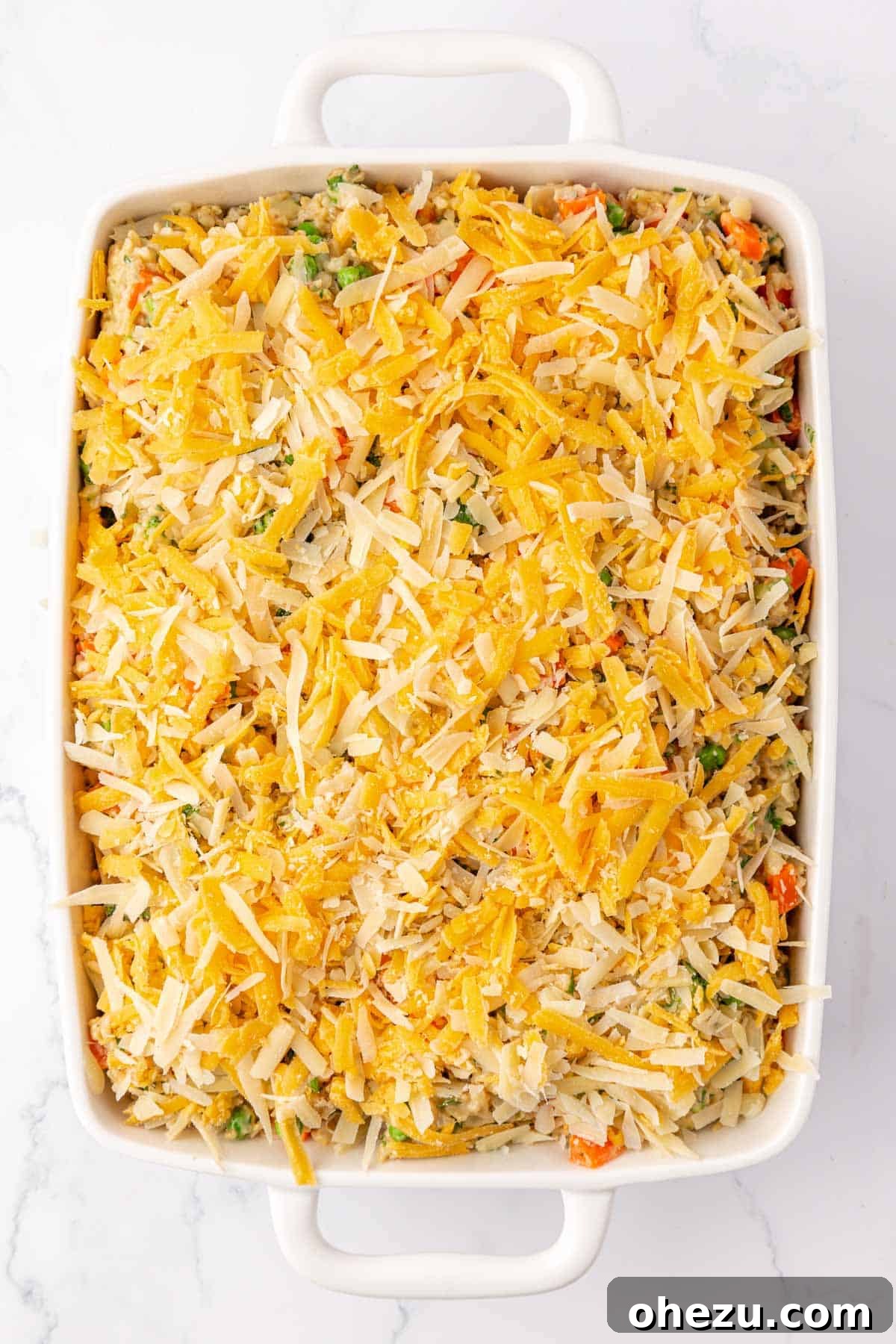 Hearty Vegetable Rice Bake 13 Topping the vegetable rice casserole with a generous layer of cheese before baking