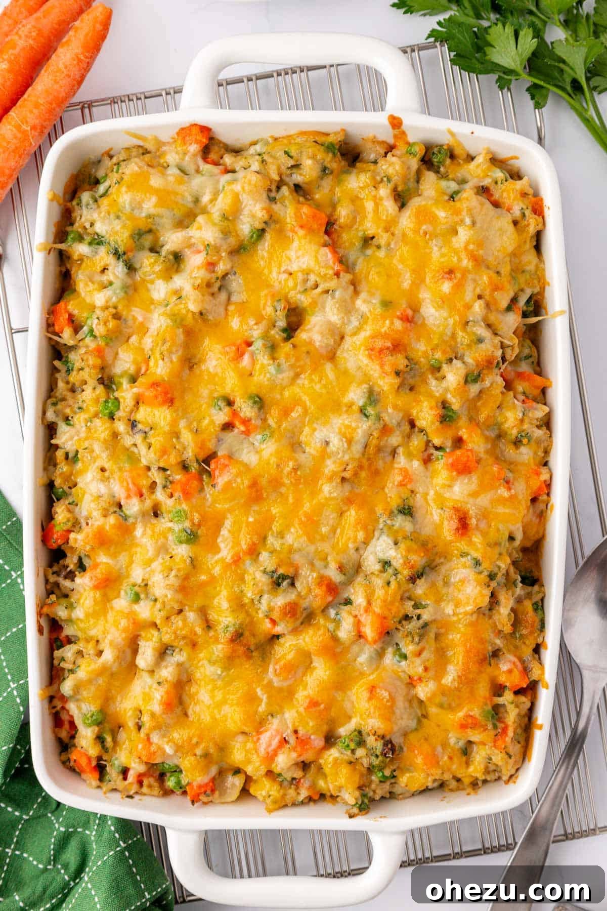 Hearty Vegetable Rice Bake 14 The unbaked vegetable rice casserole, generously topped with cheese in a baking dish