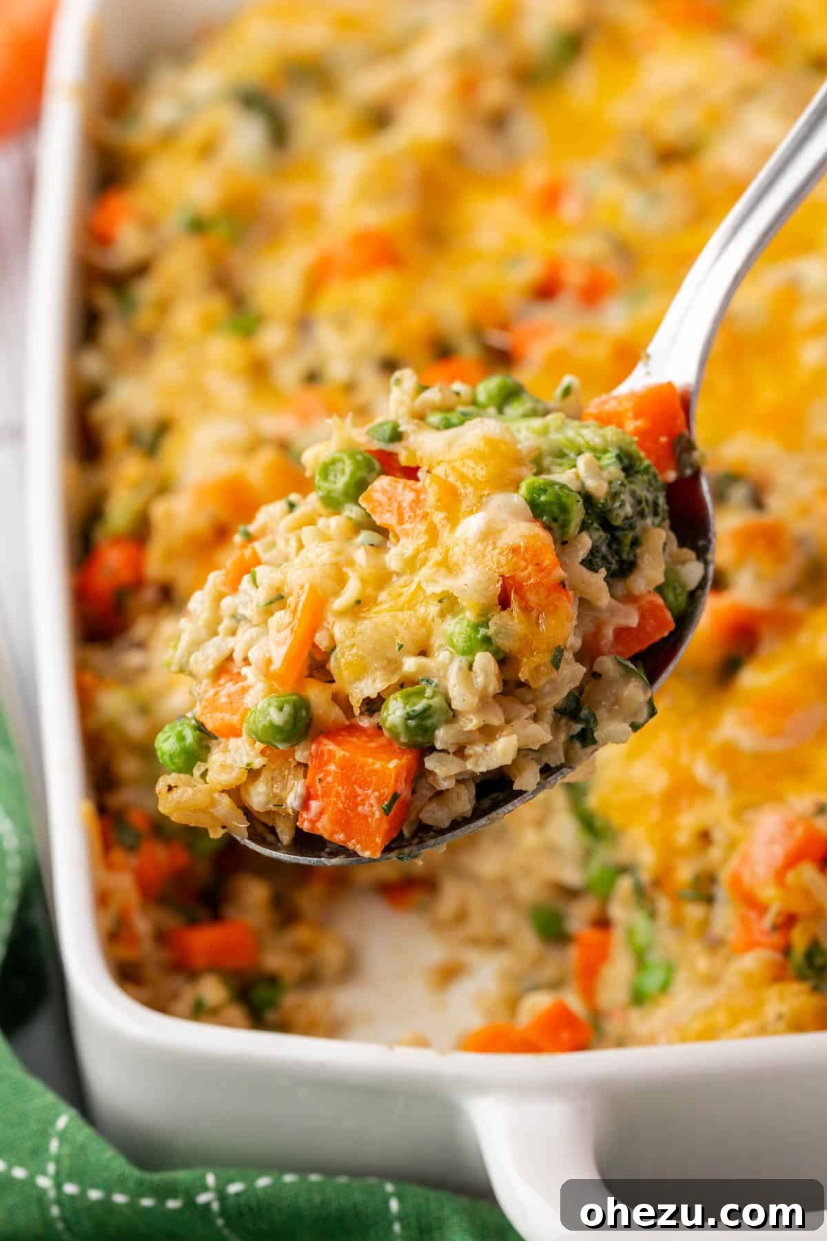 Hearty Vegetable Rice Bake 16 A close-up shot of a single serving of vegetable rice casserole, showing layers of vegetables, rice, and melted cheese