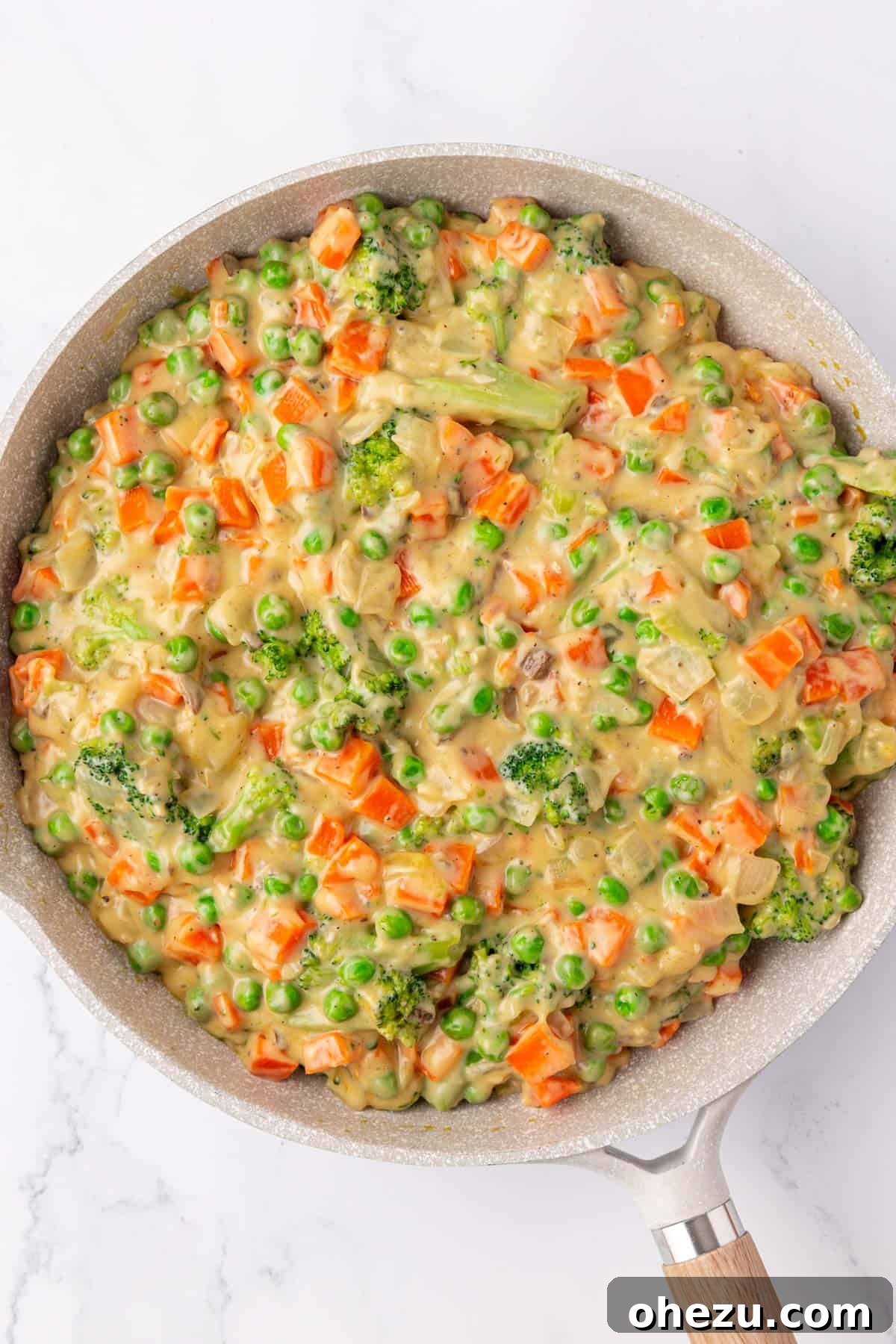 Hearty Vegetable Rice Bake 9 A close-up of the creamy, cheesy vegetable mixture simmering in the skillet